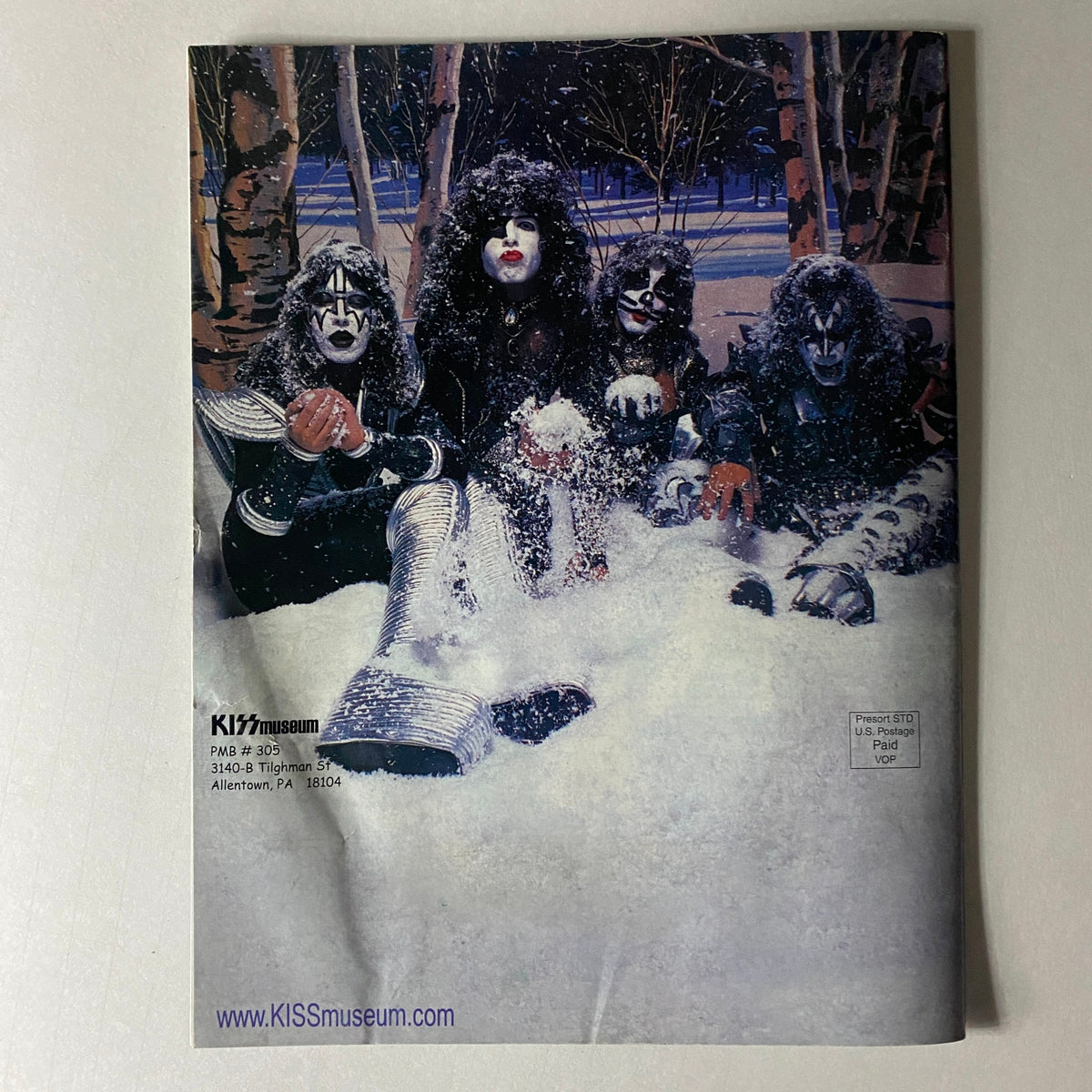 Back cover of the KISS Museum.com Catalog 2005 featuring KISS band members in a snowy scene, representing a unique piece of KISS memorabilia.