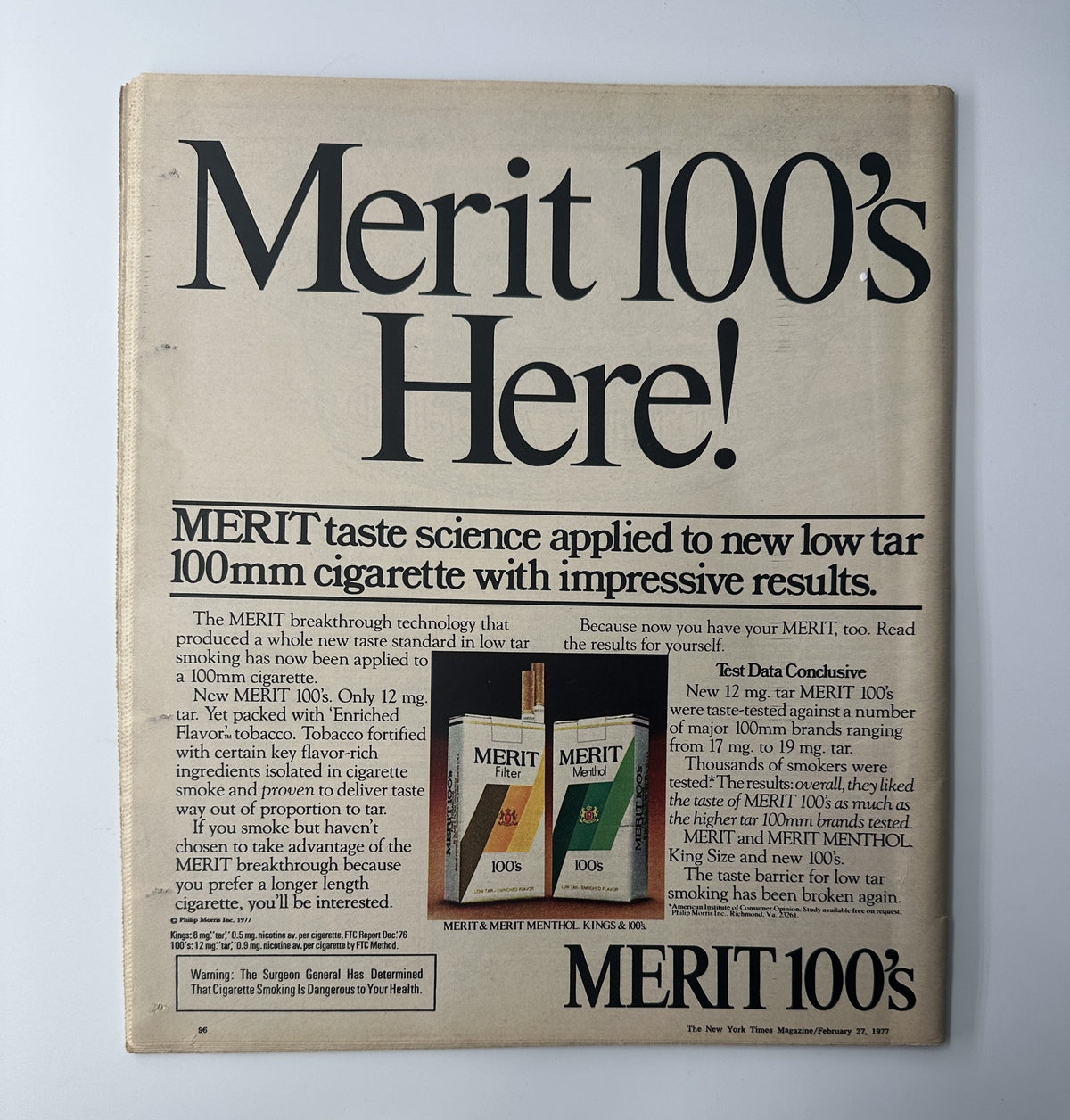 Back cover of The New York Times Magazine February 27, 1977 advertising MERIT 100's cigarettes, showcasing the product with a focus on low tar technology and appealing design.