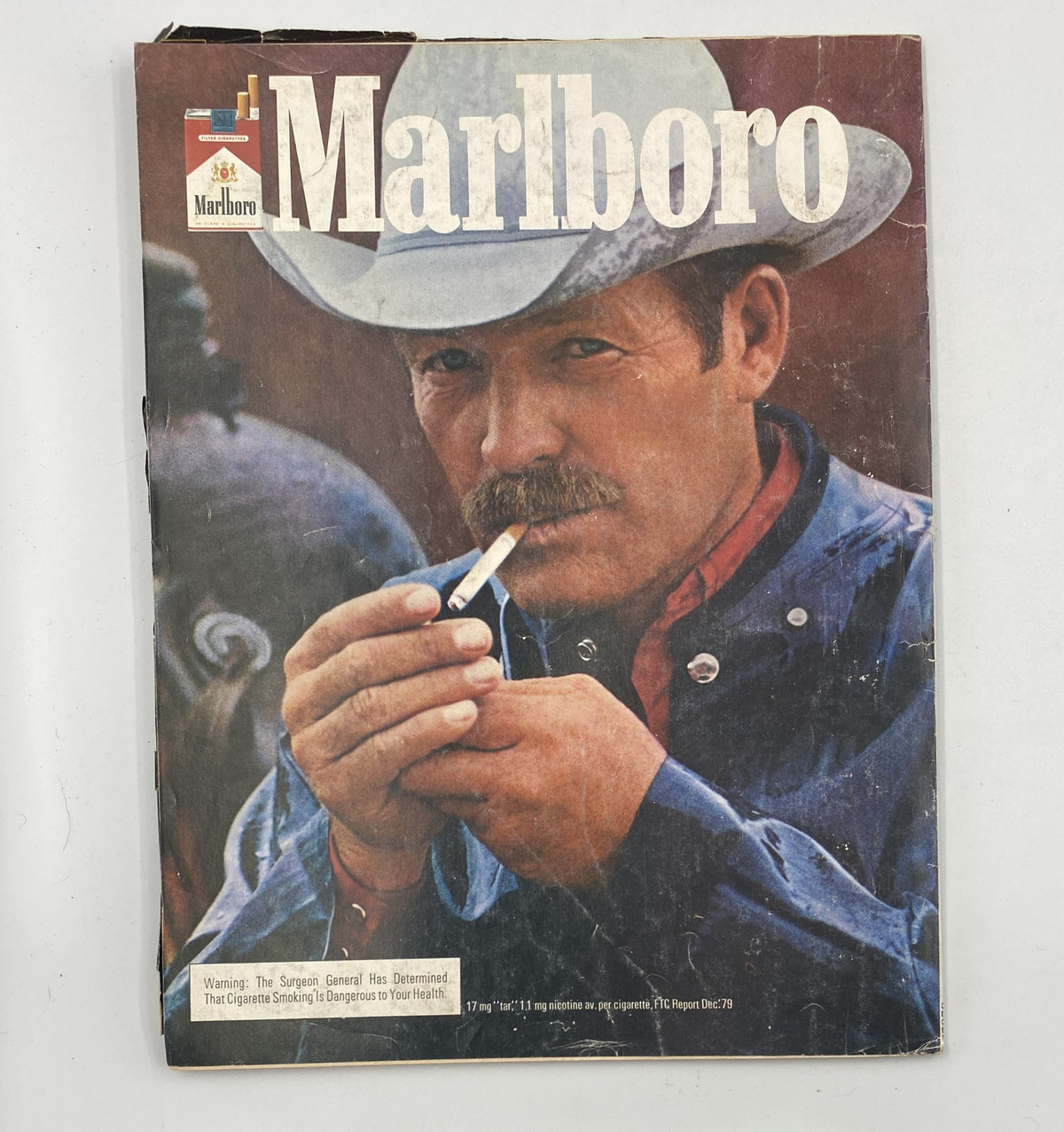 Marlboro Magazine cover depicting a cowboy with a cigarette, emphasizing the theme of Western lifestyle and rugged masculinity.