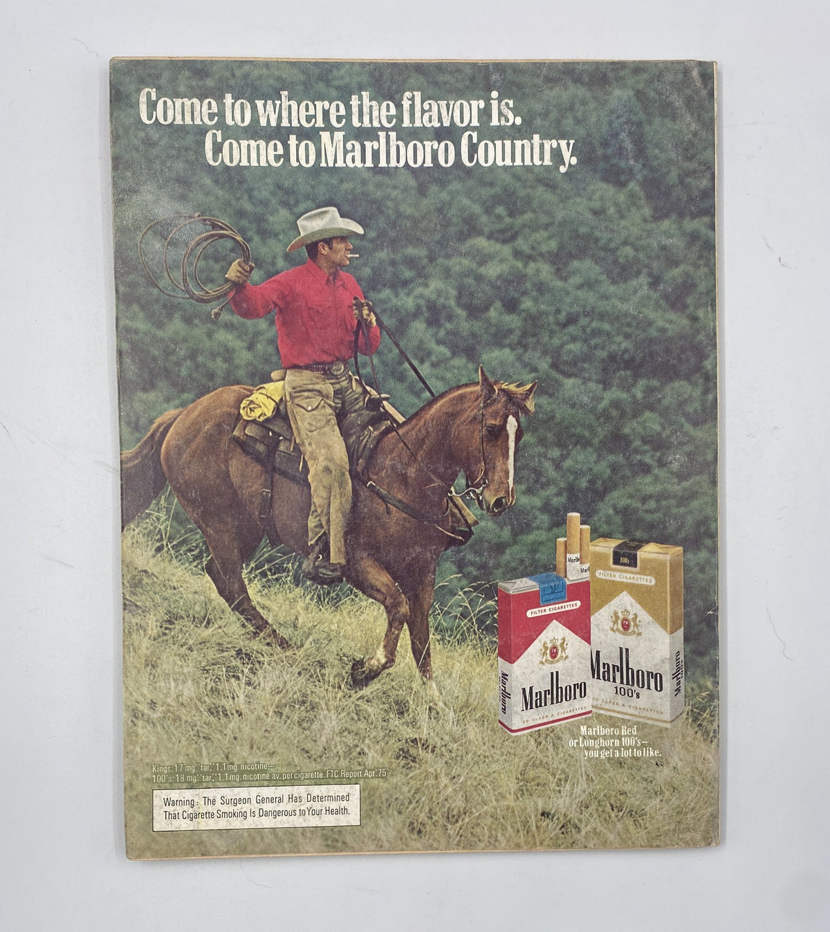 Ad page from Esquire Magazine February 1976, featuring a cowboy on horseback promoting Marlboro cigarettes. The advertisement emphasizes the slogan 'Come to where the flavor is' within a classic American setting.