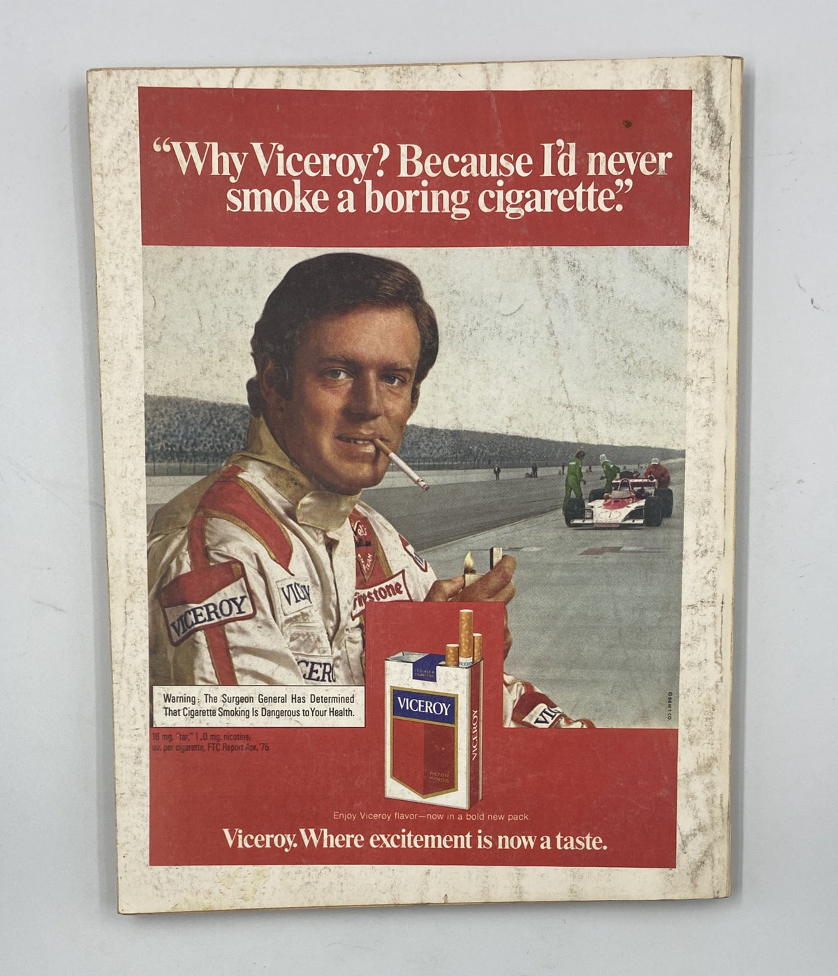 Esquire Magazine October 1975 Special Issue The Joy of Sports features a vintage advertisement with a race car driver promoting Viceroy cigarettes. The ad showcases the slogan 'Why Viceroy? Because I'd never smoke a boring cigarette,' highlighting the excitement of racing and the brand's identity. This image illustrates the style and marketing of the era.