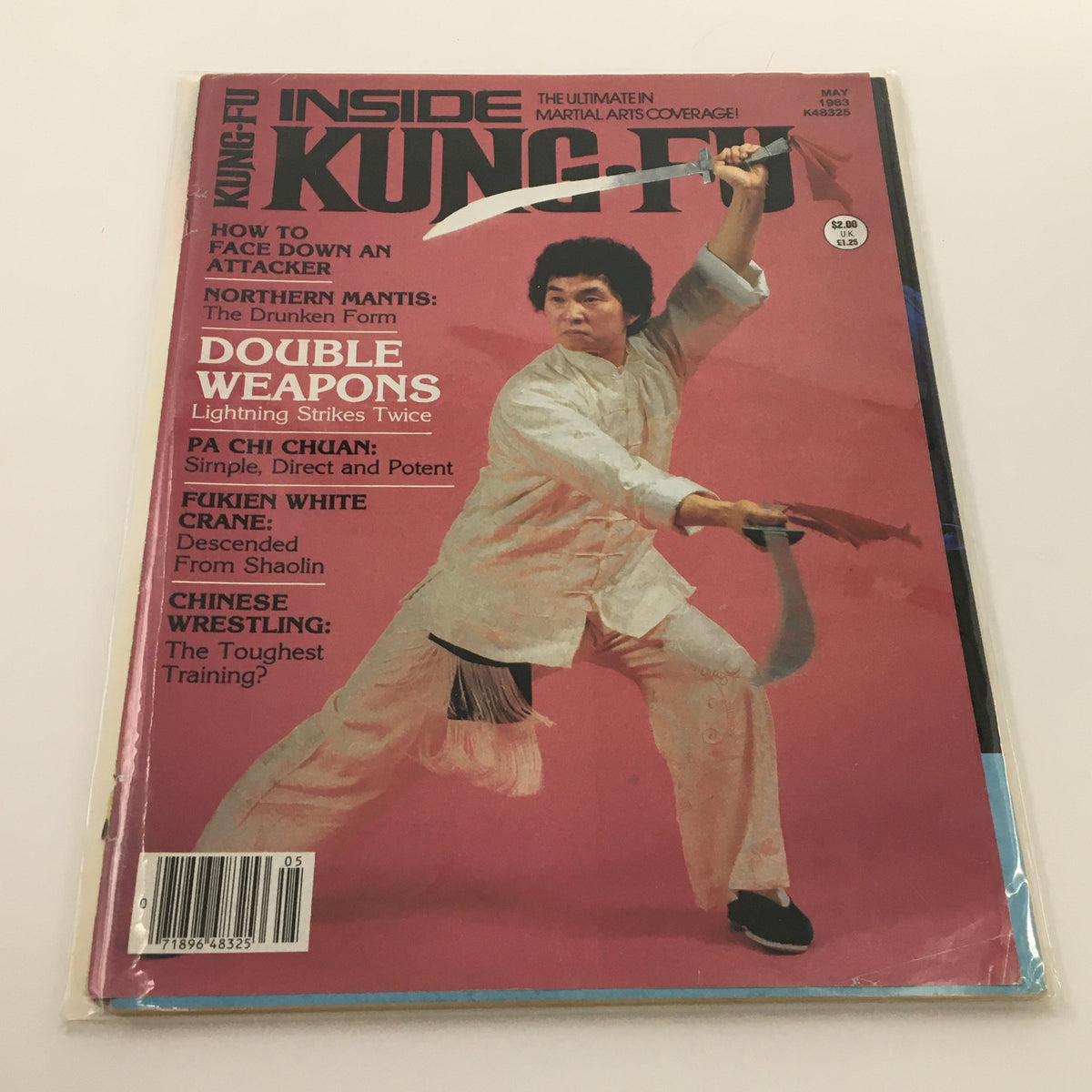 Cover of Inside Kung-Fu Magazine May 1983 featuring 'Double Weapons Strikes Twice', showcasing a martial artist demonstrating dual sword techniques.