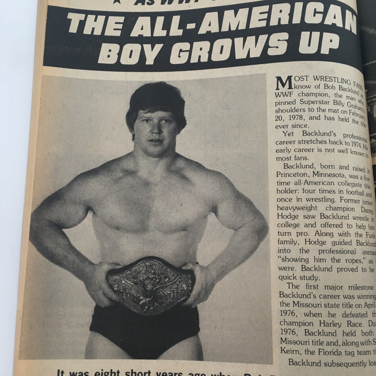 Image of Bob Backlund holding the WWF Championship title, featured in The Wrestler Magazine May 1982 article titled 'The All-American Boy Grows Up'.