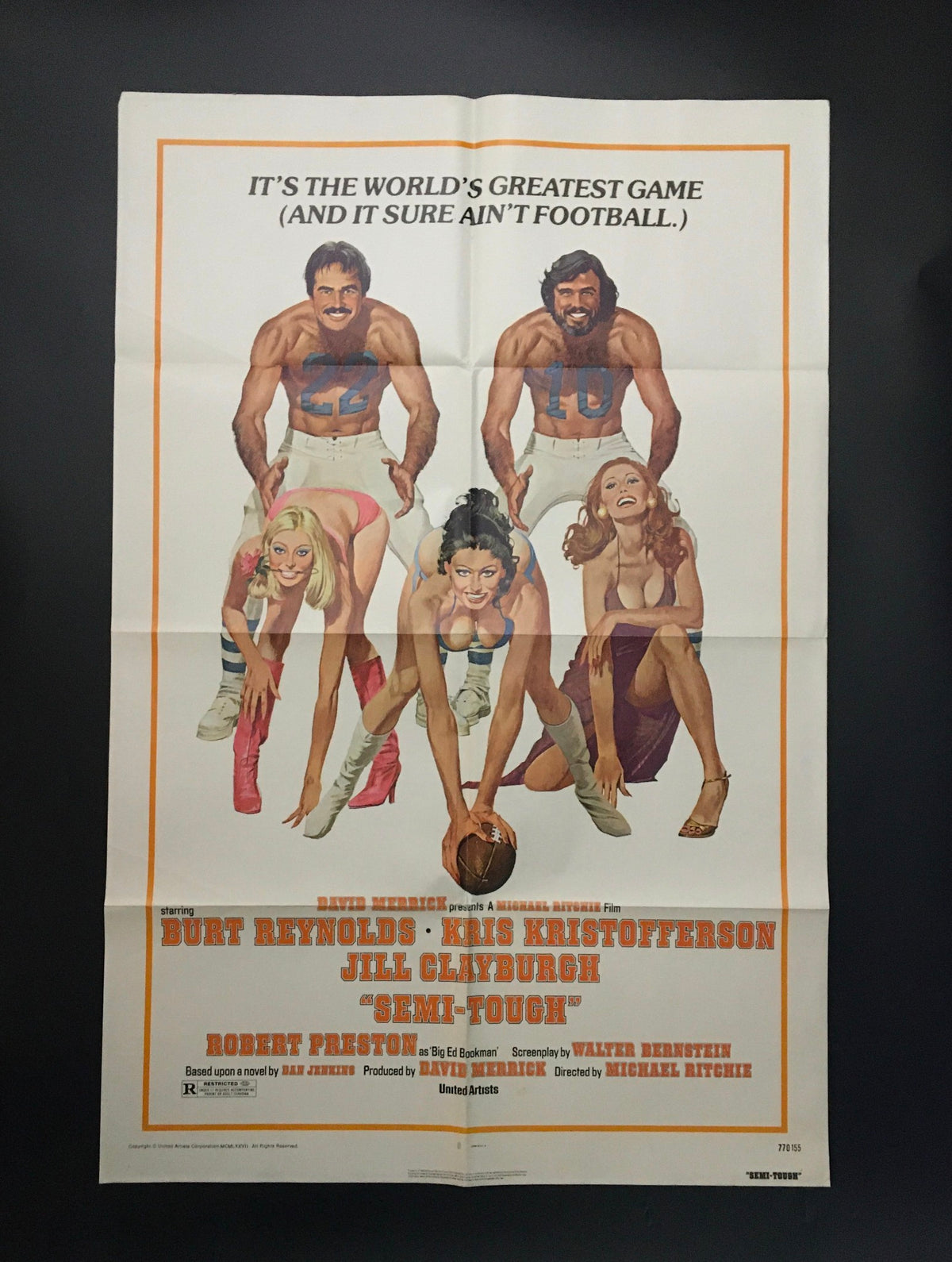 1977 Semi-Tough 41" x 27" Original Movie Poster featuring Burt Reynolds, Kris Kristofferson, and Jill Clayburgh. The poster showcases a humorous depiction of football players alongside models, capturing the comedic essence of the film.