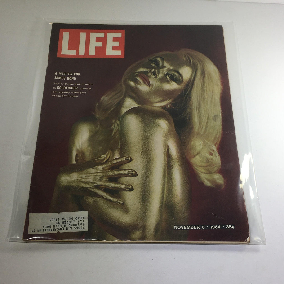 Vintage Life Magazine cover from November 6, 1964, featuring Shirley Eaton as the Gilded Victim in Goldfinger, showcasing striking gold body paint and iconic design.