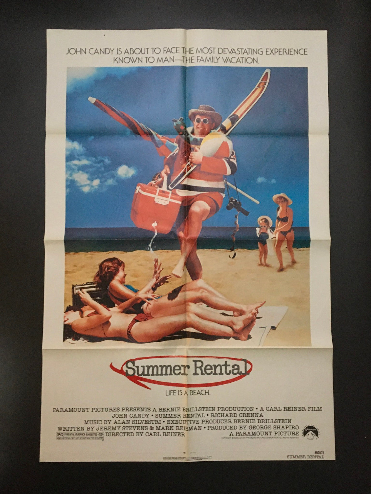1985 Summer Rental 41" x 27" Original Movie Poster featuring John Candy on a beach with surfboards and beachgoers, showcasing a comedic vacation theme.