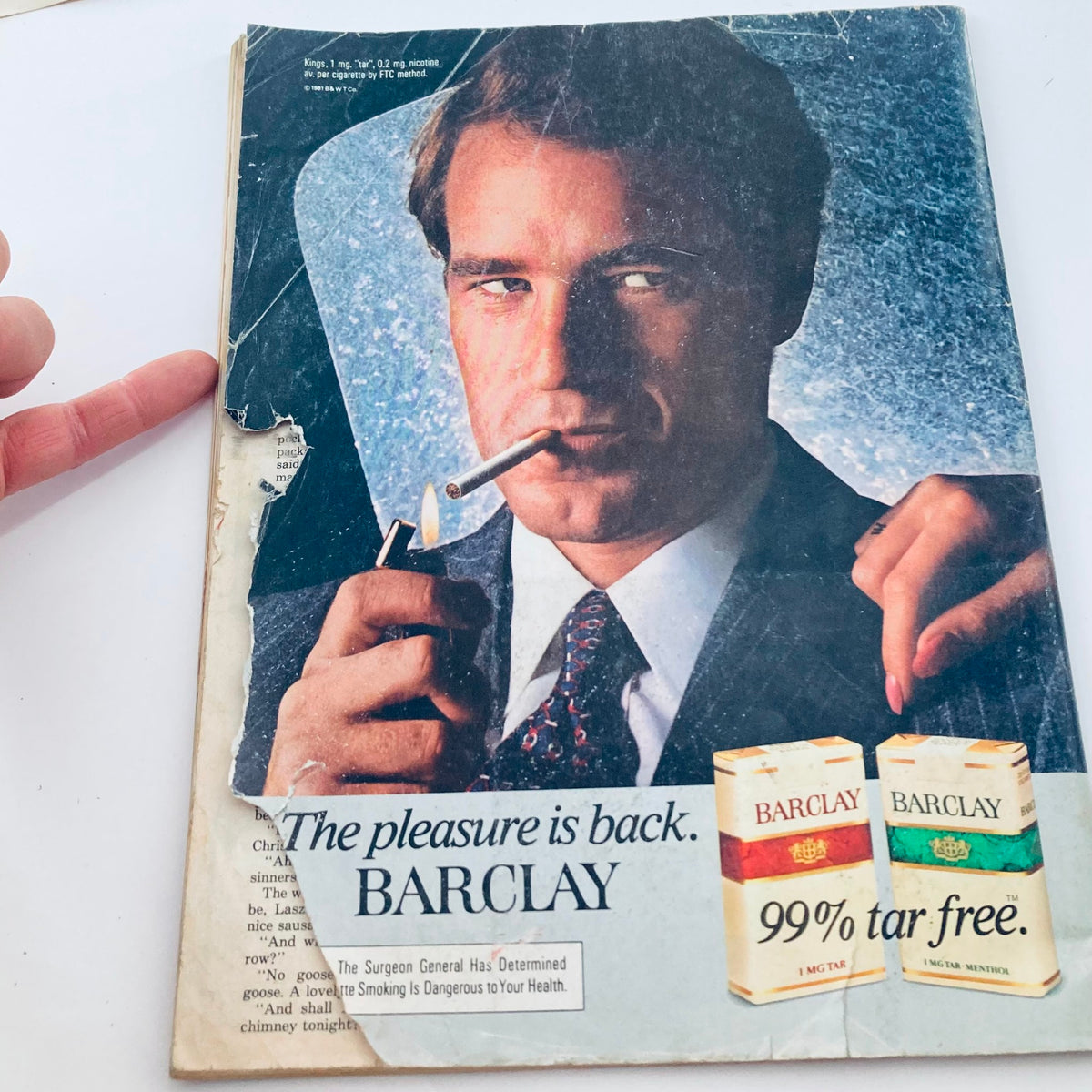 Back cover of the Saturday Evening Post Magazine, December 1981, featuring an advertisement for Barclay cigarettes, with a man in a suit holding a cigarette and a woman’s hand reaching out to him.