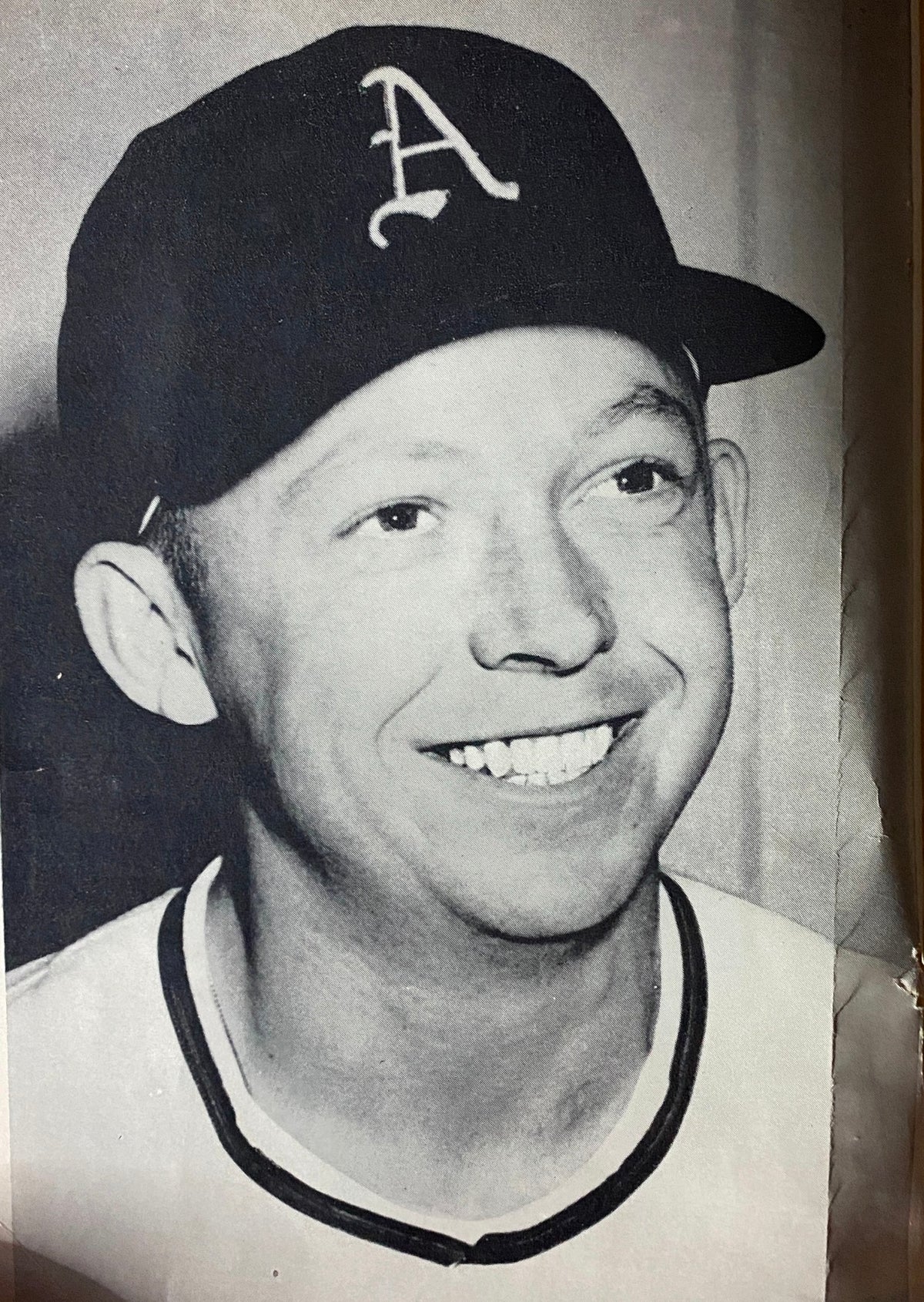 Black and white portrait of an unnamed baseball player in a cap, featured in Baseball Digest Magazine September 1954.