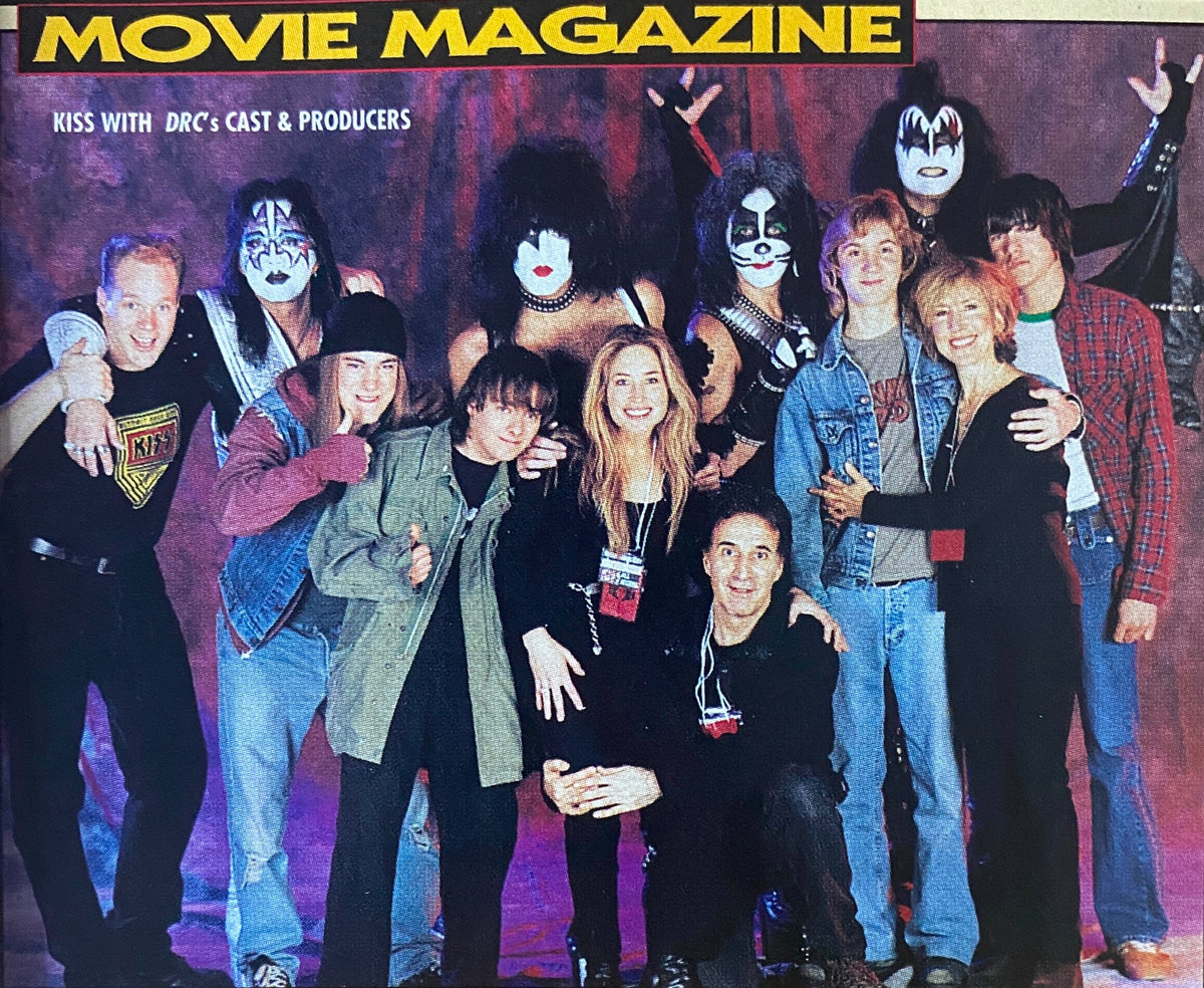 Group photo from Metal Edge Magazine Summer 1999 featuring KISS with the cast and producers of 'Detroit Rock City', celebrating the film's release and rock culture.