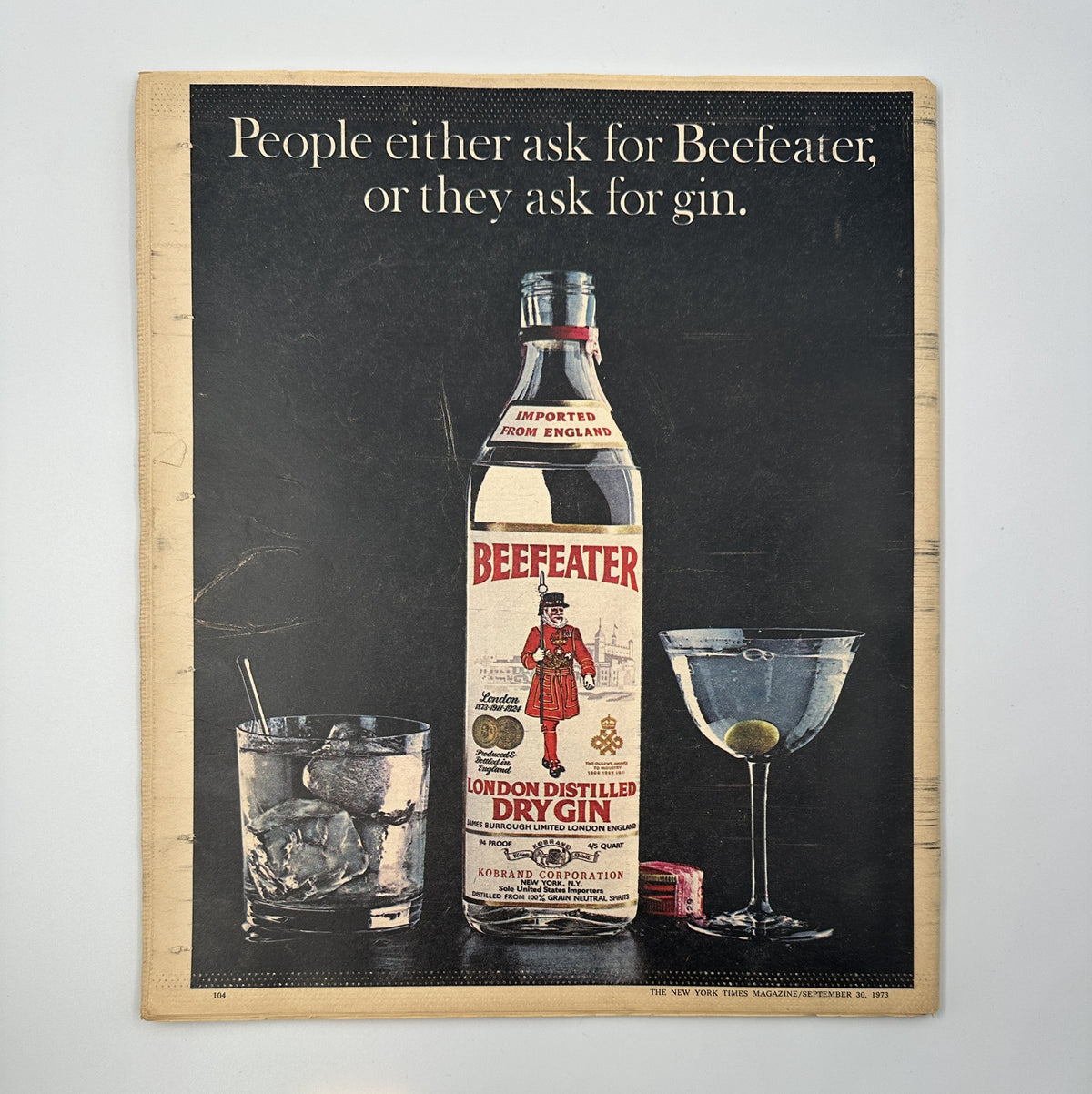 Magazine advertisement for Beefeater London Distilled Dry Gin, featuring a large bottle and glasses with drinks, from The New York Times Magazine September 30, 1973 Senator Baker Watergate issue.