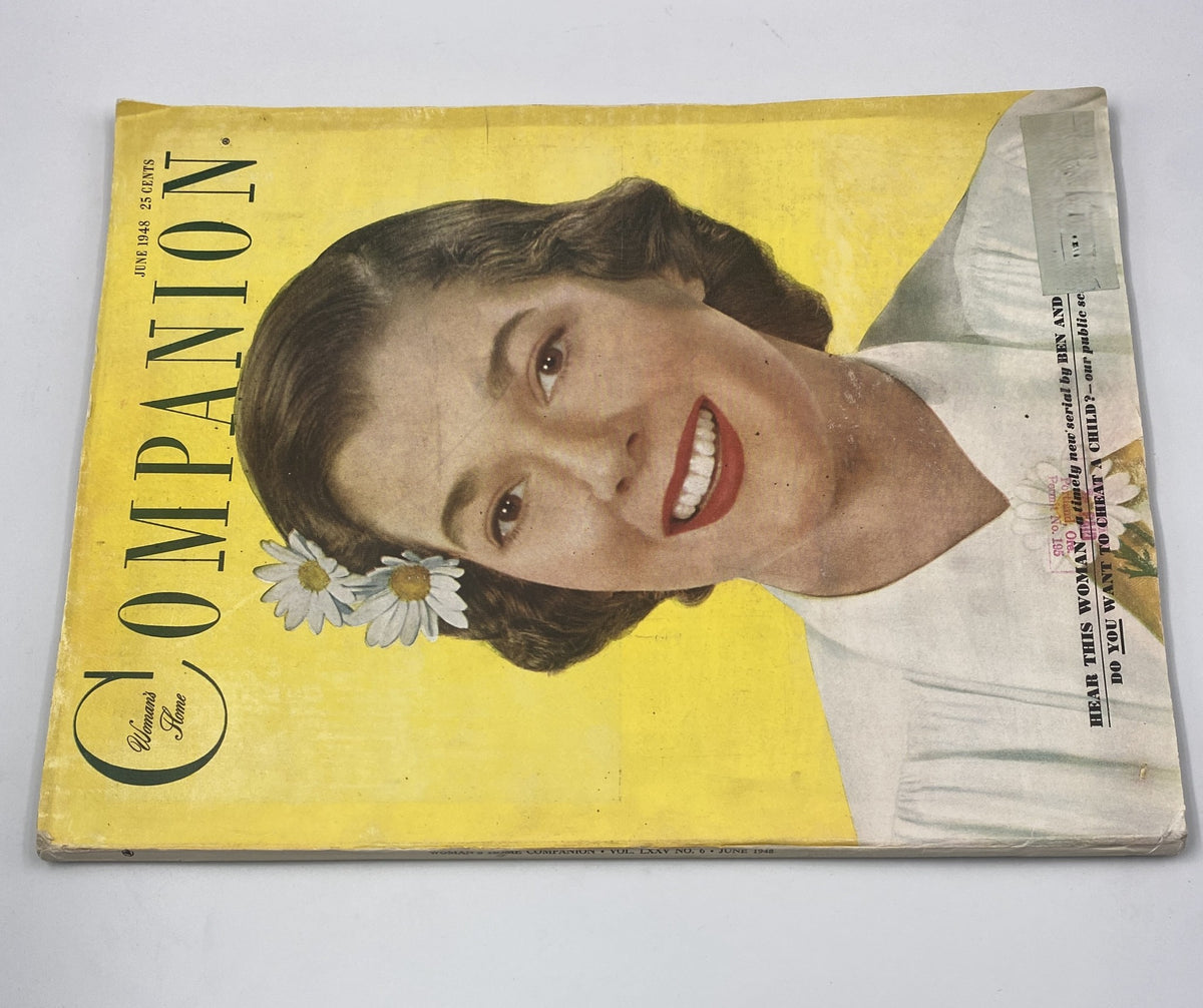 Front cover of Woman’s Home Companion Magazine, June 1948, showcasing a cheerful woman with daisies, highlighting the serial 'Hear This Woman' and a tagline about cheating children.