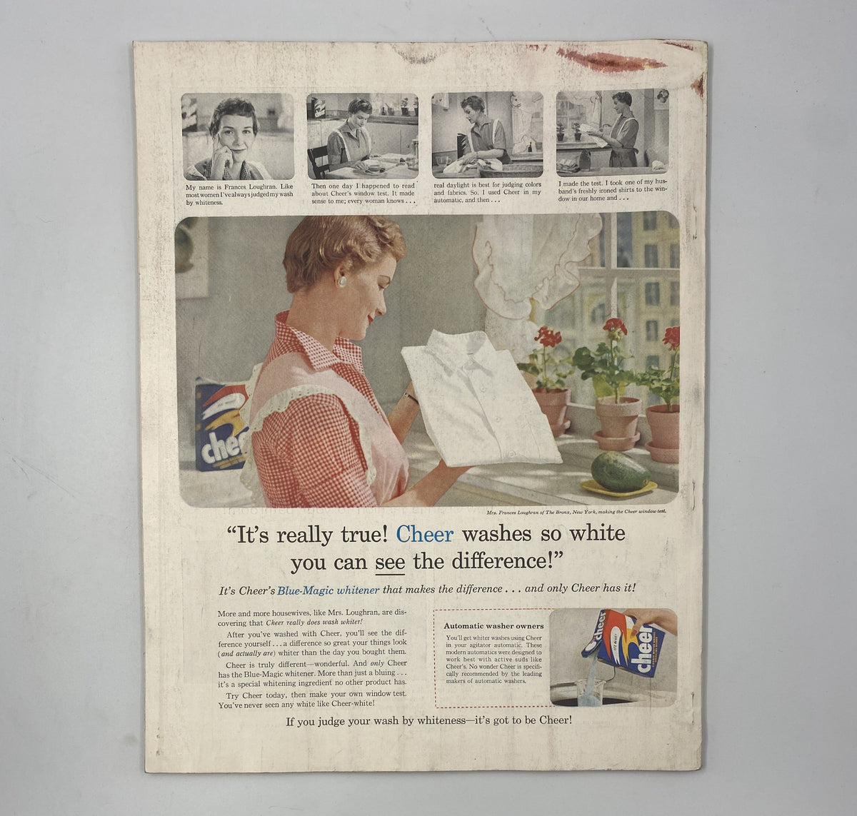 Vintage advertisement featuring a woman using Cheer laundry detergent while smiling at freshly washed linen. The illustration showcases the product's effectiveness with the slogan "It's really true! Cheer washes so white you can see the difference!" This image is associated with the Woman’s Home Companion Magazine August 1956, highlighting household tips and products.