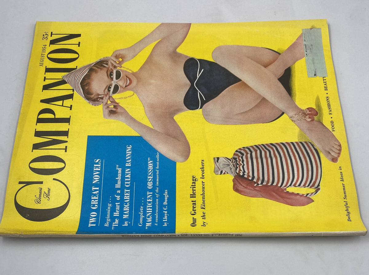 Woman’s Home Companion Magazine August 1954 Eisenhower Fashion Cover featuring a stylish woman in a swimsuit and a striped sun hat against a bright yellow background.