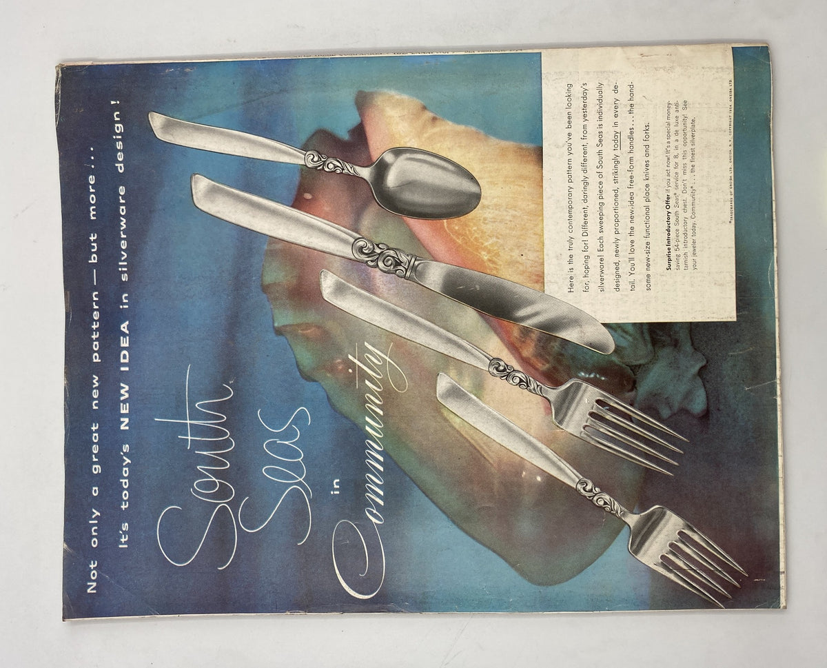 Back cover of Woman’s Home Companion Magazine September 1954 highlighting silverware design with text about South Seas in Community, illustrating mid-century style.