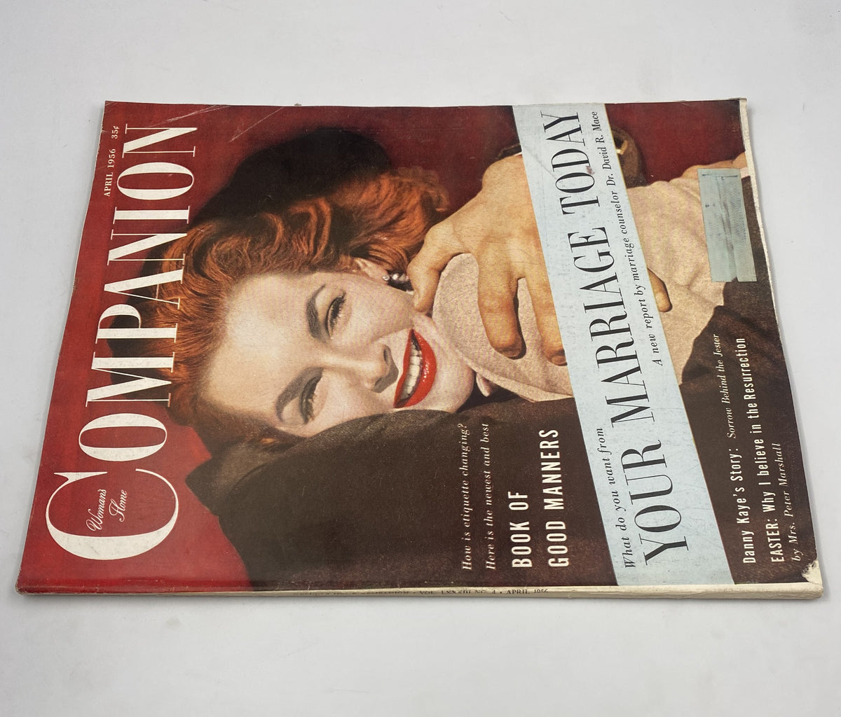 Second view of the Woman’s Home Companion Magazine April 1956 cover, showcasing a smiling woman and the title prominently displayed. The cover emphasizes themes of marriage and good manners.