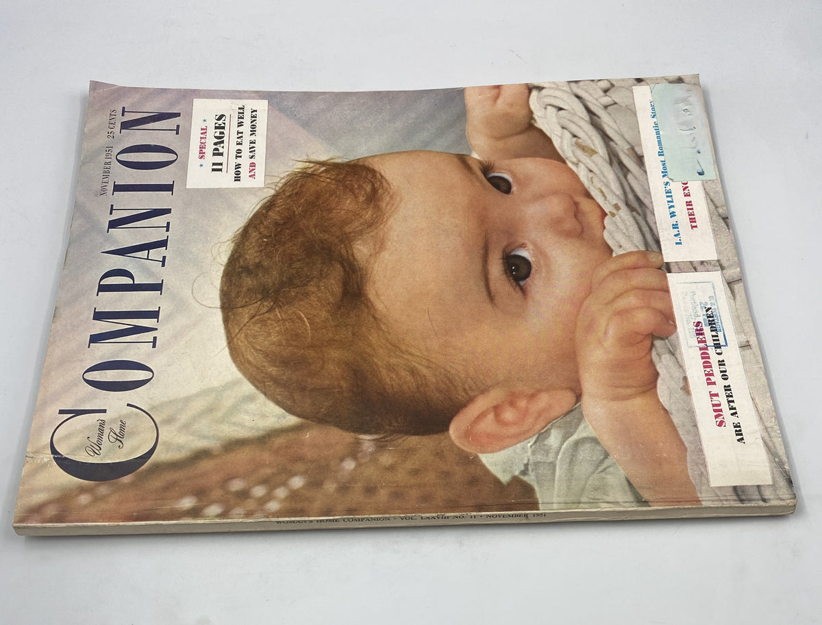 Another angle of the Woman's Home Companion Magazine from November 1951, showcasing its cover design. The magazine contains articles on parenting and household management, emphasizing the need for child protection.