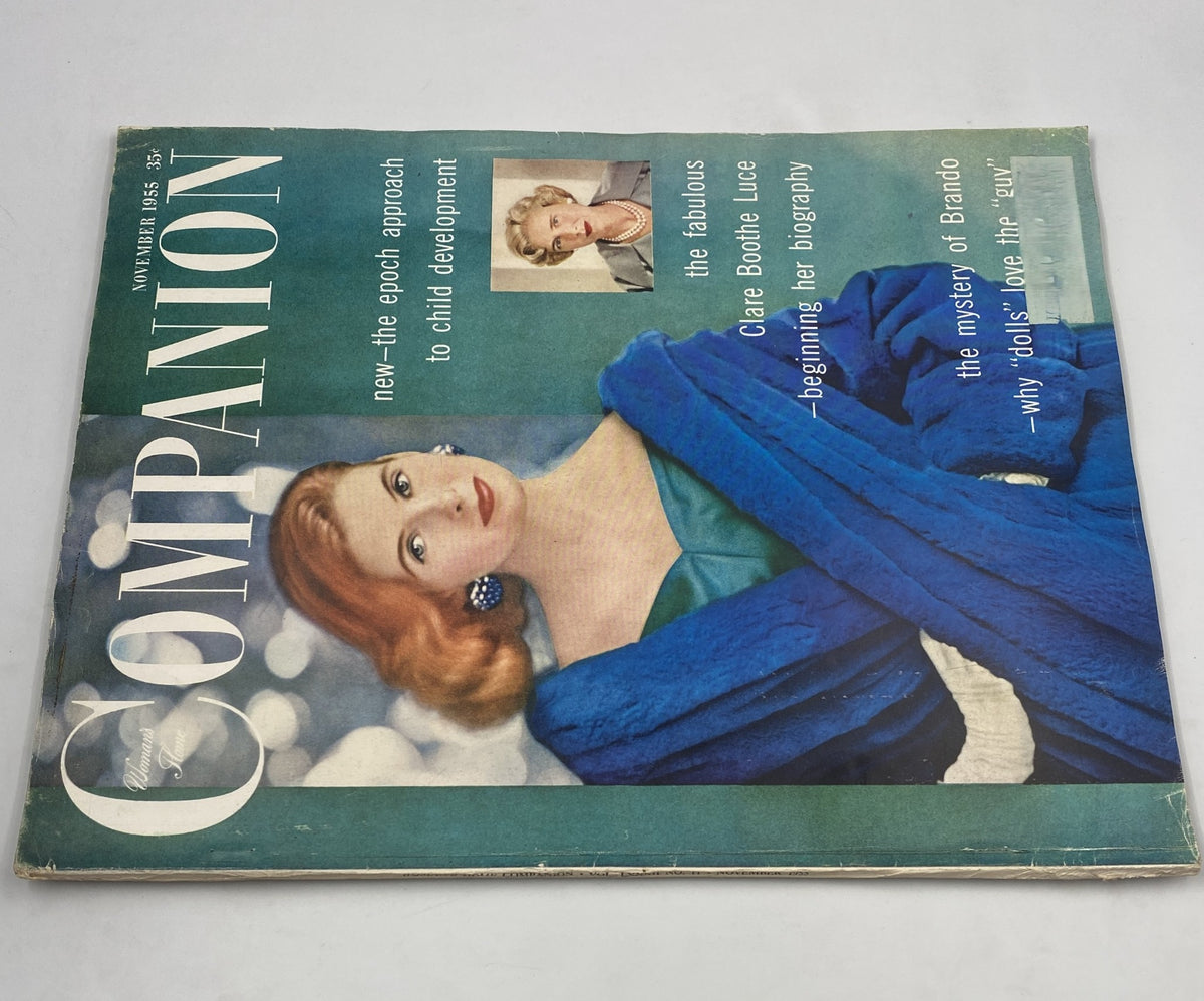 Woman’s Home Companion Magazine November 1955 featuring Clare Boothe Luce and Marlon Brando on the cover, showcasing a vintage design with a model in a blue coat.