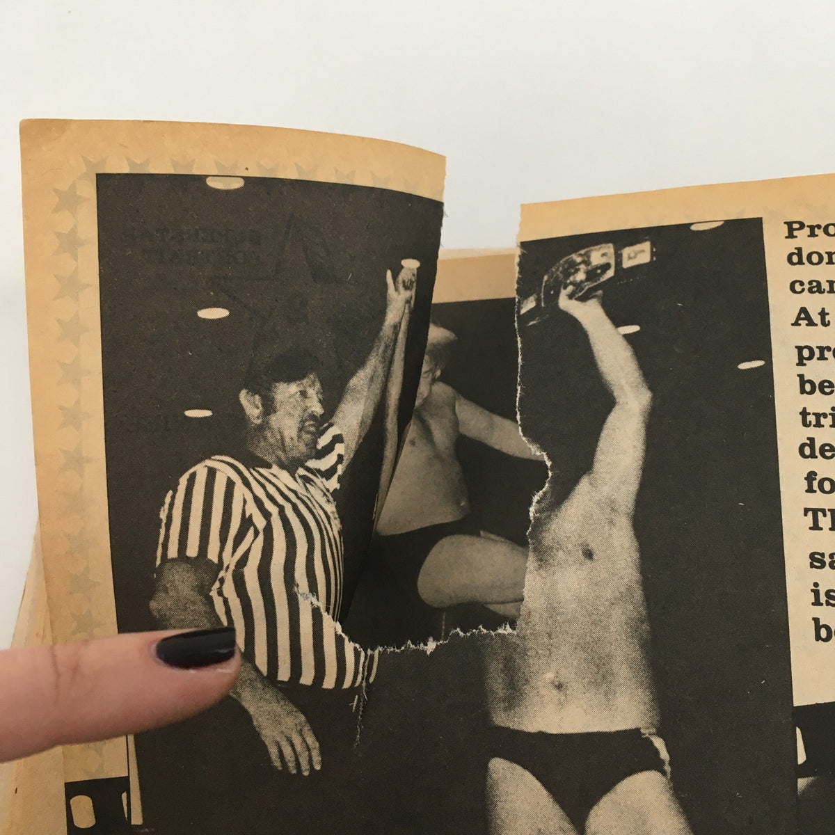 Torn page in Wrestling Superstars Magazine Spring 1980 depicting a wrestling match scene with a referee and competitors.