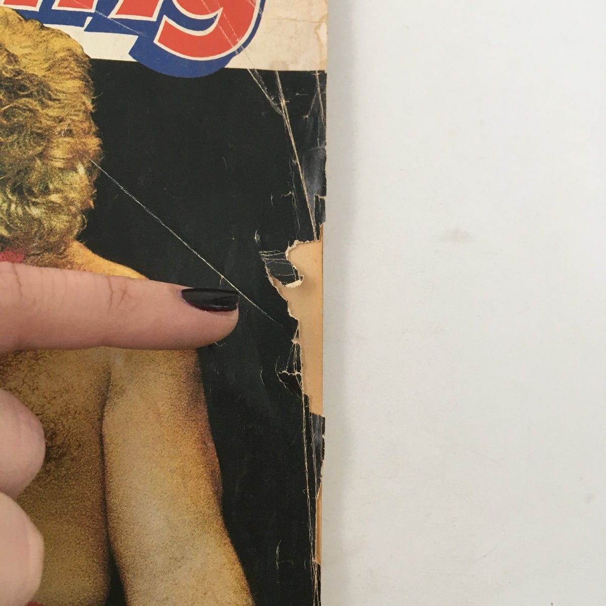 Close-up of wear and tear on the cover of Inside Wrestling Magazine, February 1980, highlighting its vintage condition.