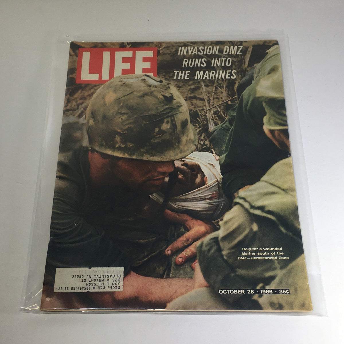 Cover of VTG Life Magazine: October 28, 1966 - Invasion DM Zone Runs Into The Marines, depicting a soldier assisting a wounded marine during military operations.