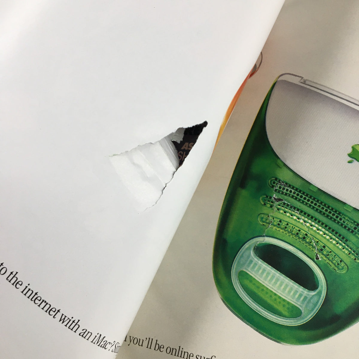 Interior page with a rip from Spin Magazine July 1999, featuring a green iMac advertisement, highlighting notable technology from the late 1990s.