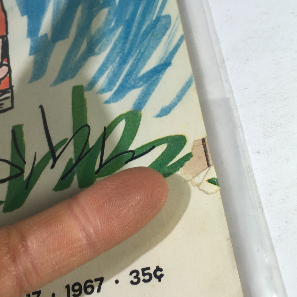 Close-up of the March 17, 1967 Life Magazine cover detailing, showing the corner with minor wear and a signature, highlighting the vintage charm of the publication featuring Charlie Brown and Snoopy.