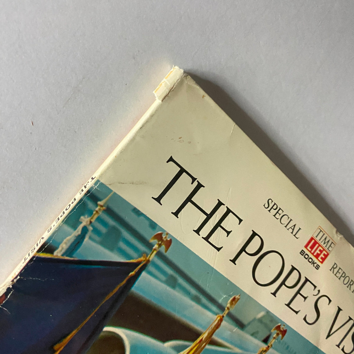 Close-up view of the corner of the 1965 Time Life Special Report: The Pope's Visit magazine, showing wear and tear that adds to its vintage collectibility.