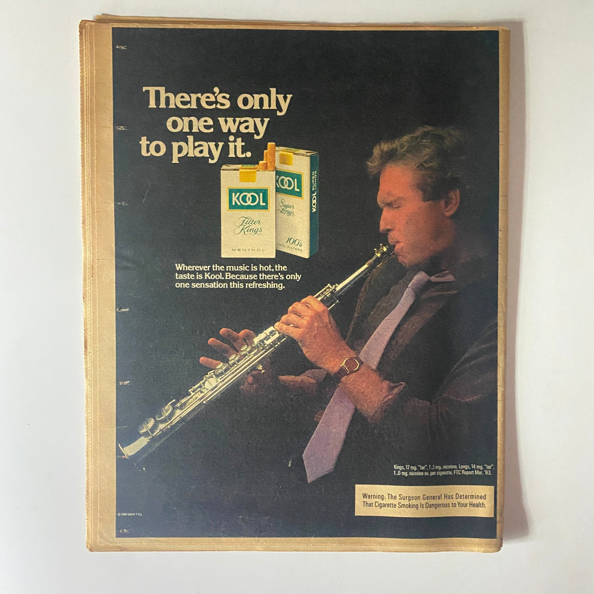 National Enquirer February 14 1984 advertisement for Kool cigarettes with a man playing a clarinet, promoting the brand's unique taste.