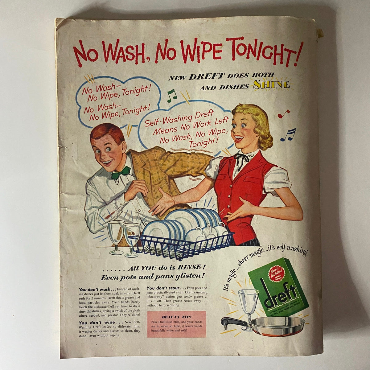 Vintage advertisement from the May 1951 issue of Ladies' Home Journal featuring a cheerful couple promoting Dreft dishwashing detergent with the slogan 'No Wash, No Wipe Tonight!' This retro ad highlights the convenience of self-washing Dreft for easy dish cleaning.