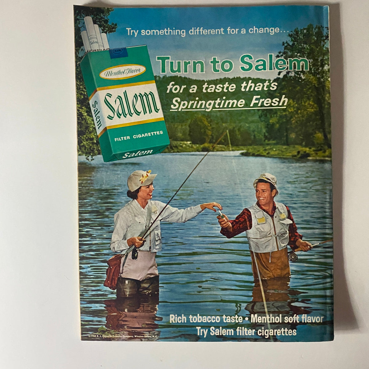 Cover of the December 1965 Better Homes & Gardens Magazine featuring a couple fishing, with a Salem cigarettes pack promotion that emphasizes its menthol flavor, showcasing the outdoor lifestyle of the mid-60s.