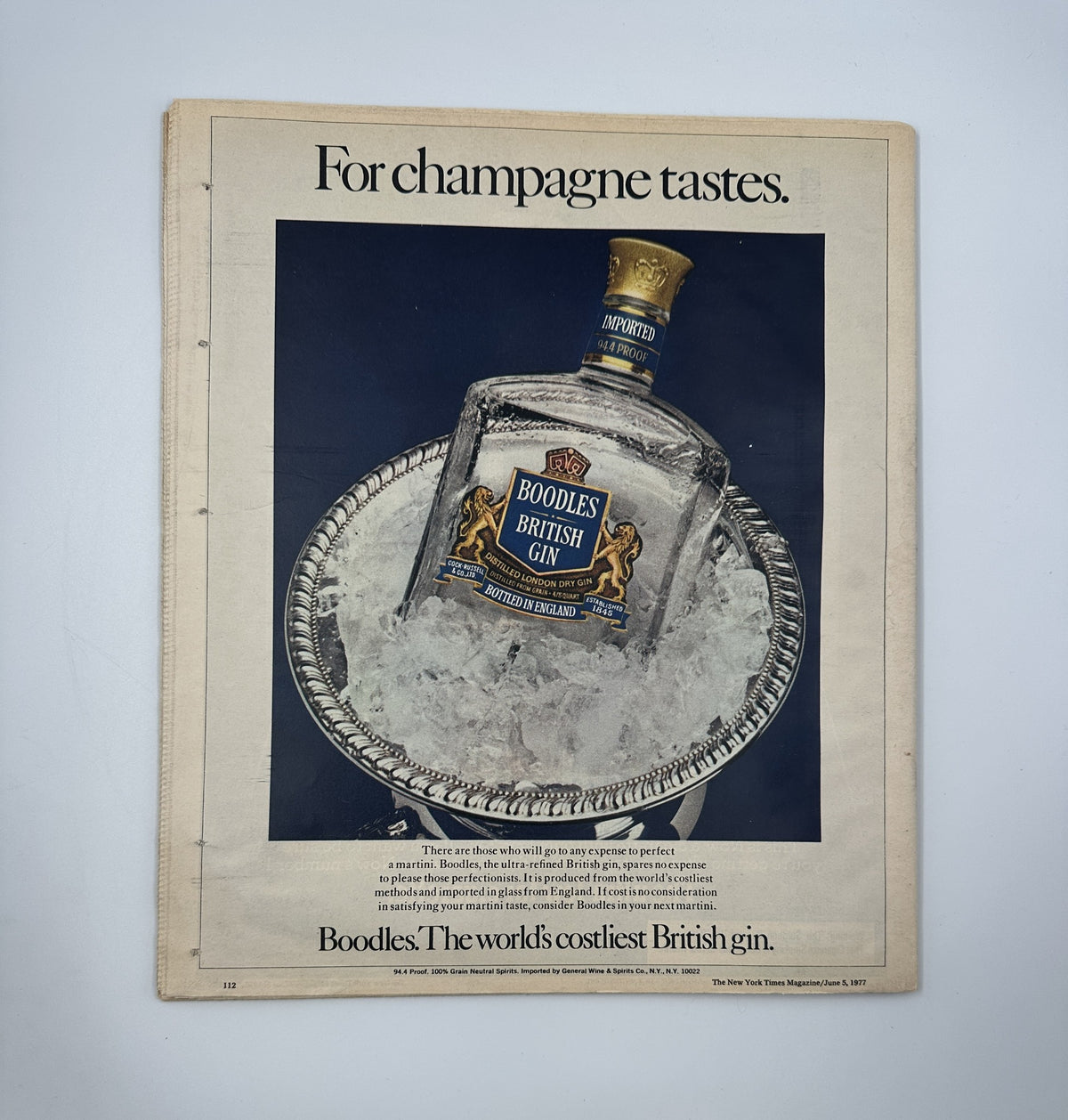 The New York Times Magazine June 5, 1977 showcases an advertisement for Boodles British Gin, claiming to be the world's costliest British gin. The image depicts the gin bottle on ice, highlighting its premium quality.