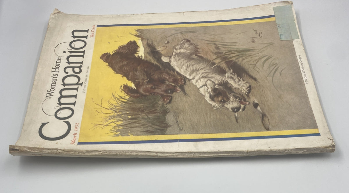 Another view of the Woman’s Home Companion Magazine March 1932 cover, highlighting the illustration of two playful dogs by Cecil Aldin, with noticeable wear and historical appeal.