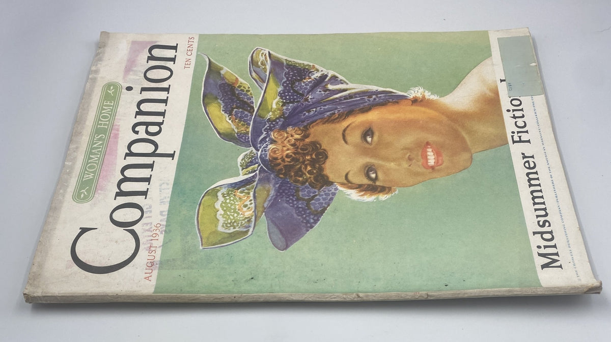 Side view of Woman's Home Companion Magazine August 1936 Midsummer Fiction showing the magazine cover with vibrant colors and design elements.