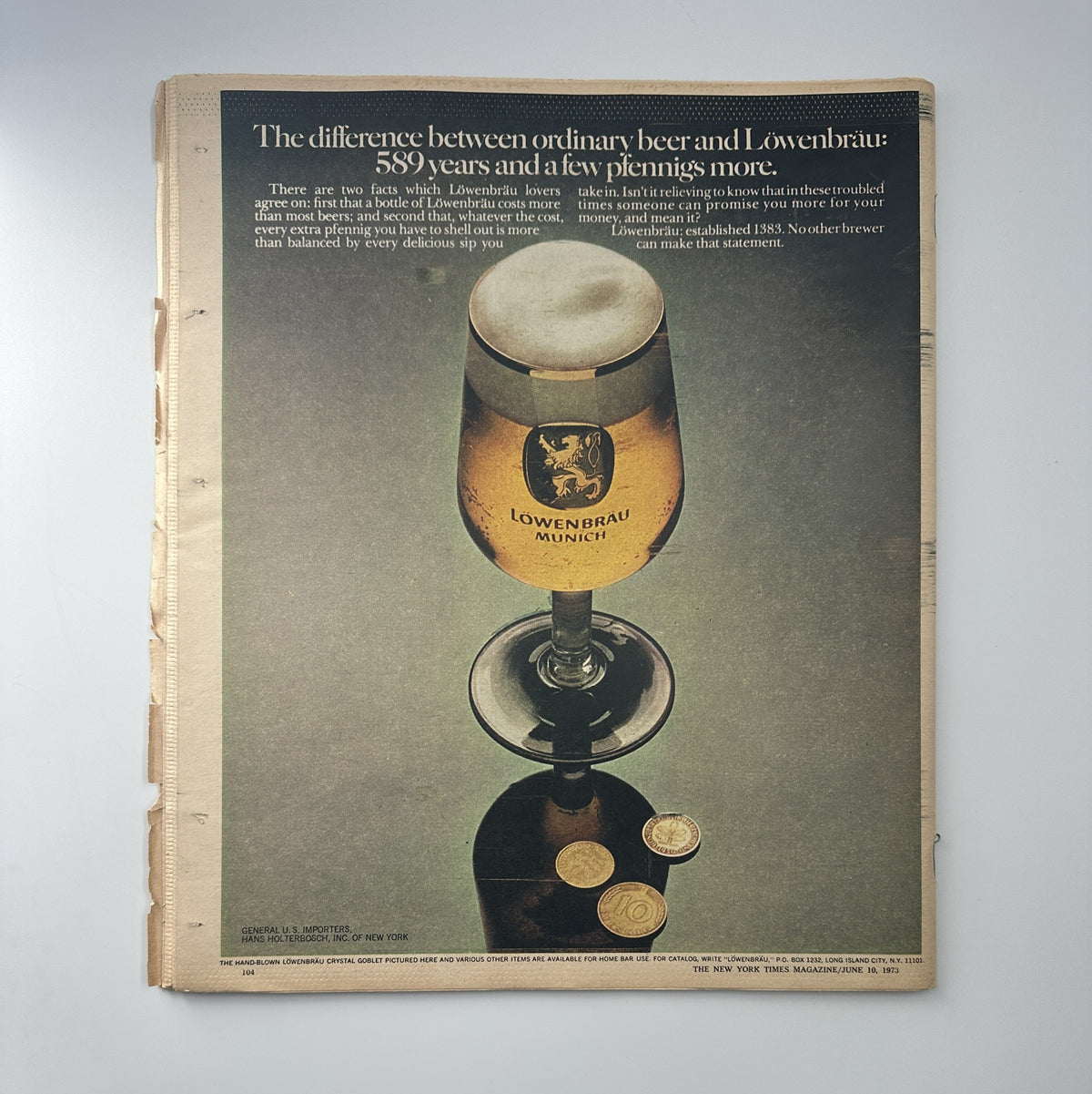 Back cover of The New York Times Magazine June 10, 1973 showcasing an advertisement for Löwenbräu beer, with a glass of beer elegantly displayed on a pedestal.