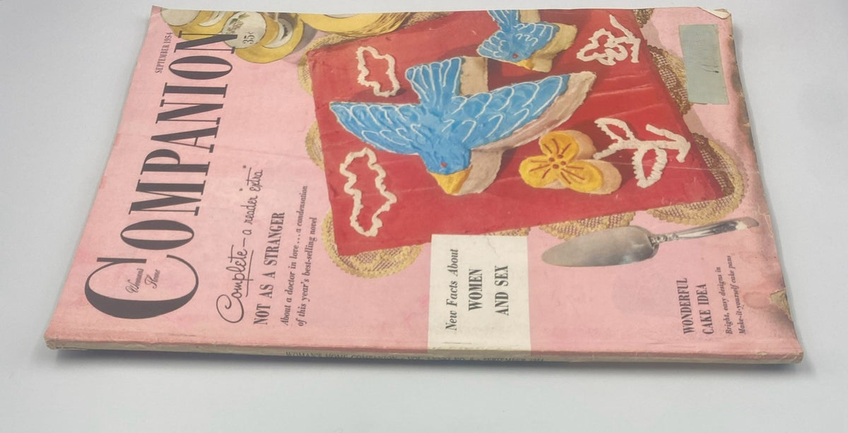 Side view of the Woman’s Home Companion Magazine September 1954 showcasing the vibrant cover art with cake designs and the title 'Not As a Stranger'.