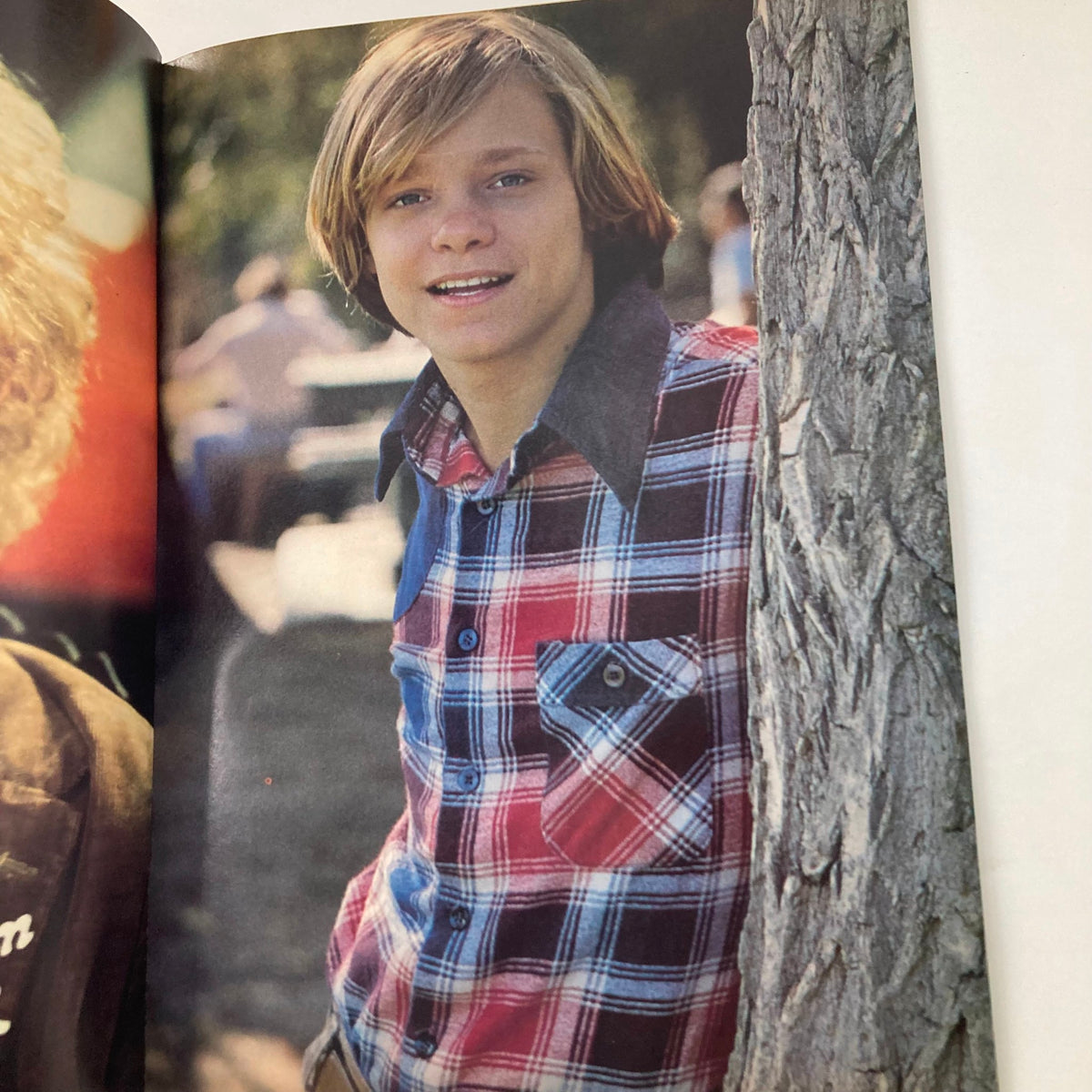 Page from the VTG Teen Bag Magazine Spring 1978 featuring a smiling young man in a plaid shirt against a tree, capturing the essence of 1970s style.