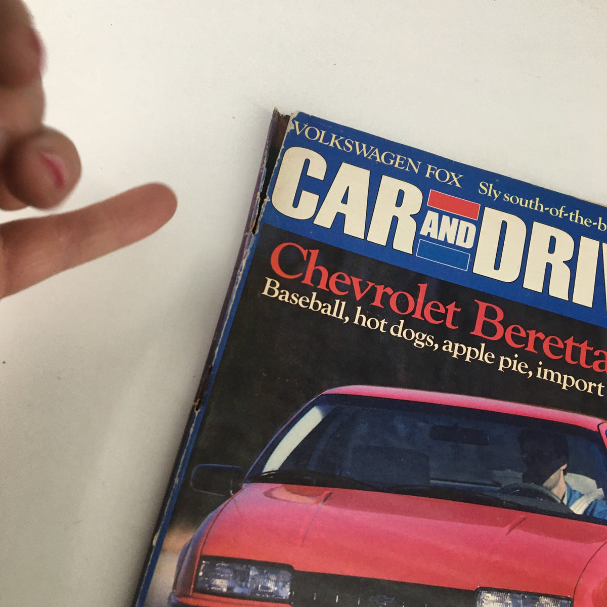Close-up of the Car and Driver Magazine February 1987 cover showcasing the Chevrolet Beretta GT, emphasizing its import rivalry theme and vintage automotive design.