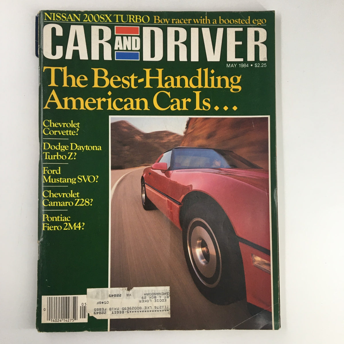 Cover of Car and Driver Magazine May 1984 featuring the Nissan 200SX Turbo, described as a 'Boy Racer with a Boosted Ego'. The cover includes features on leading American cars like Chevrolet Corvette, Dodge Daytona Turbo Z, and more, showcasing a red sports car in motion on a winding road.