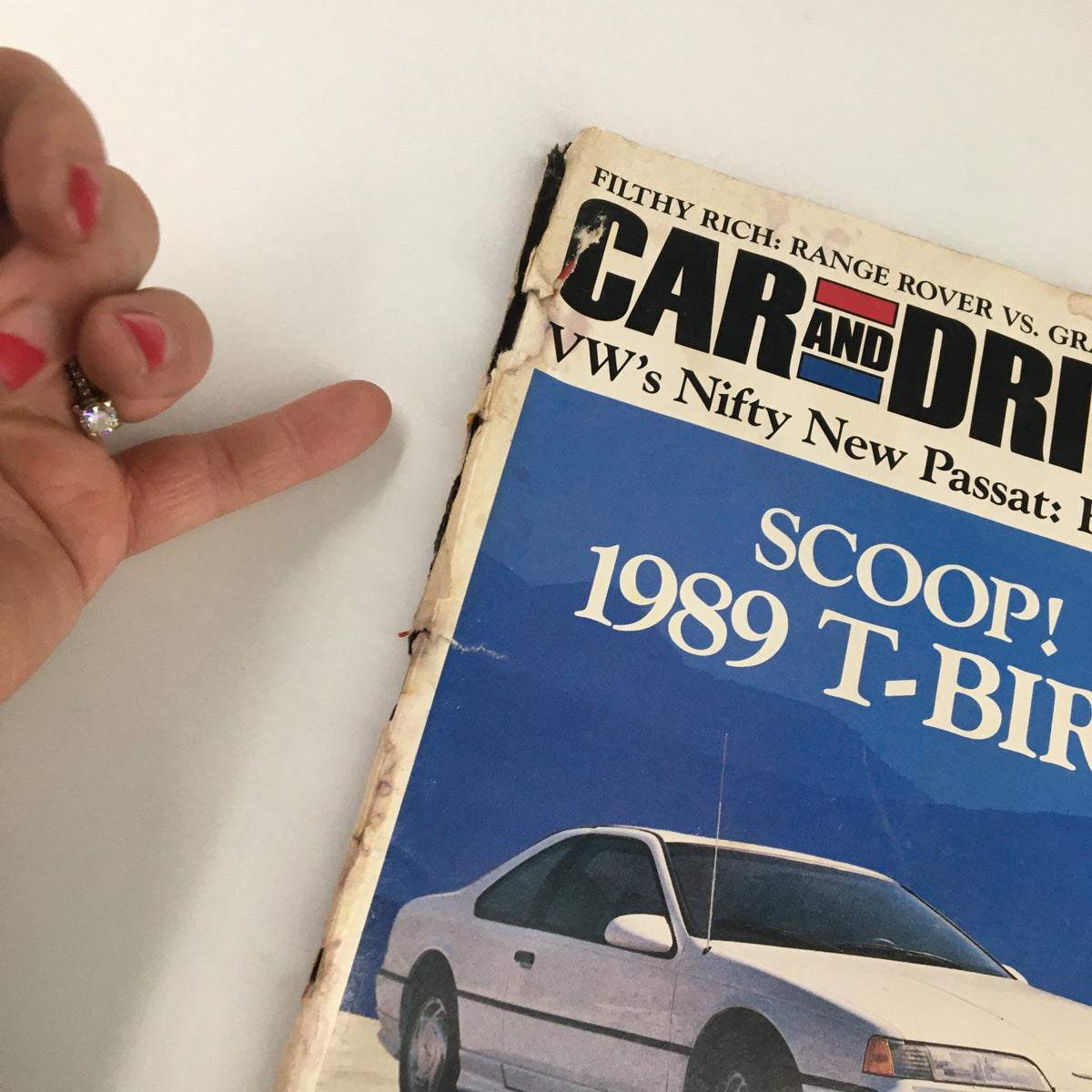 Detail view of the cover of Car and Driver Magazine July 1988, highlighting VW's Nifty New Passat with a hand gesture indicating its vintage appeal.