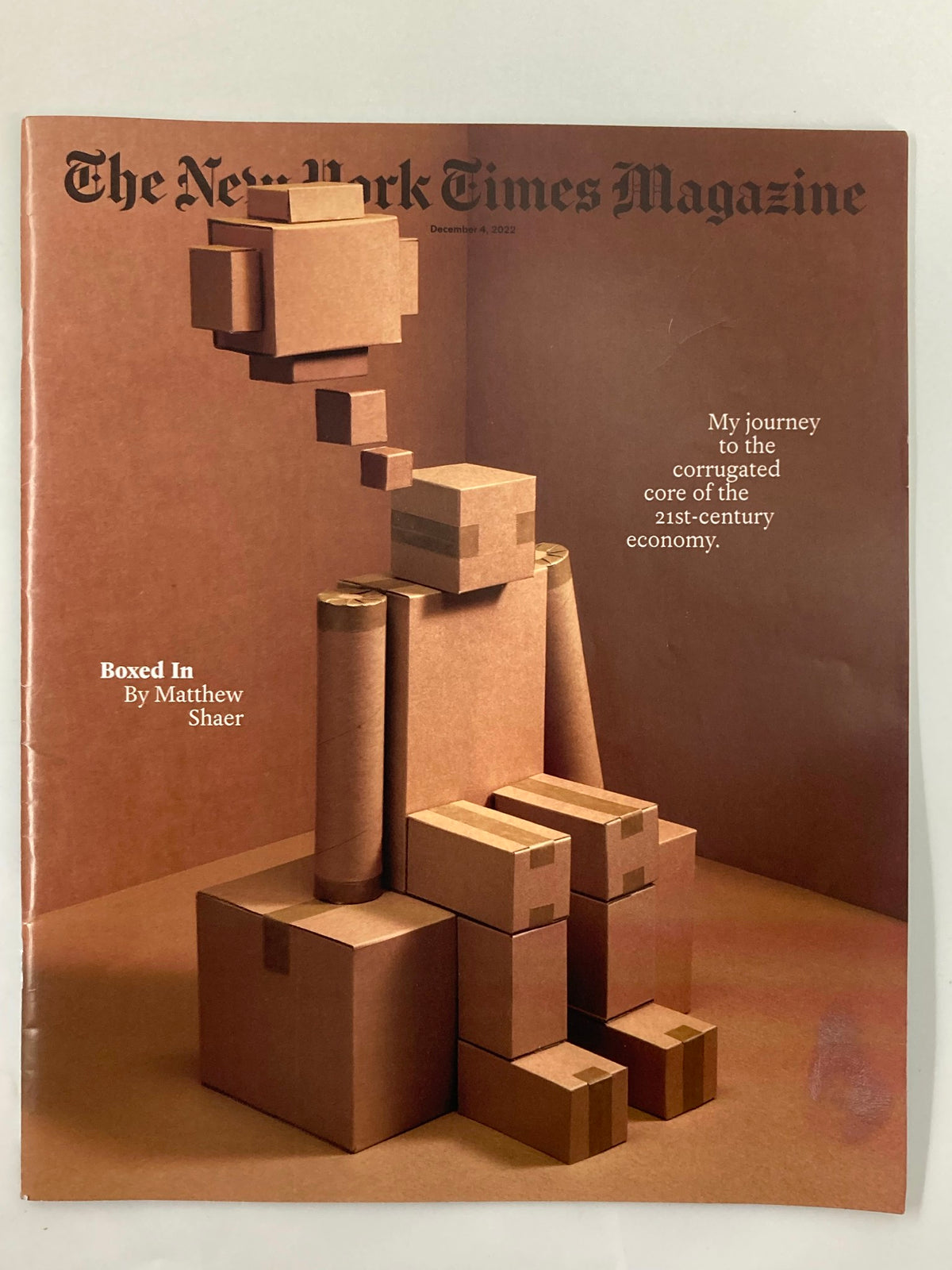 The New York Times Magazine December 4 2022 cover featuring artistic depiction of cardboard figures representing the themes of the 21st-century economy, titled 'Boxed In' by Matthew Shaer.