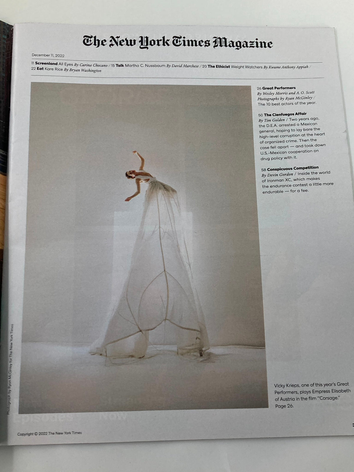 Inside spread of The New York Times Magazine December 11, 2022, featuring an artistic photograph of a model in an elegant white dress, accompanying the article on great performers including Michelle Yeoh.