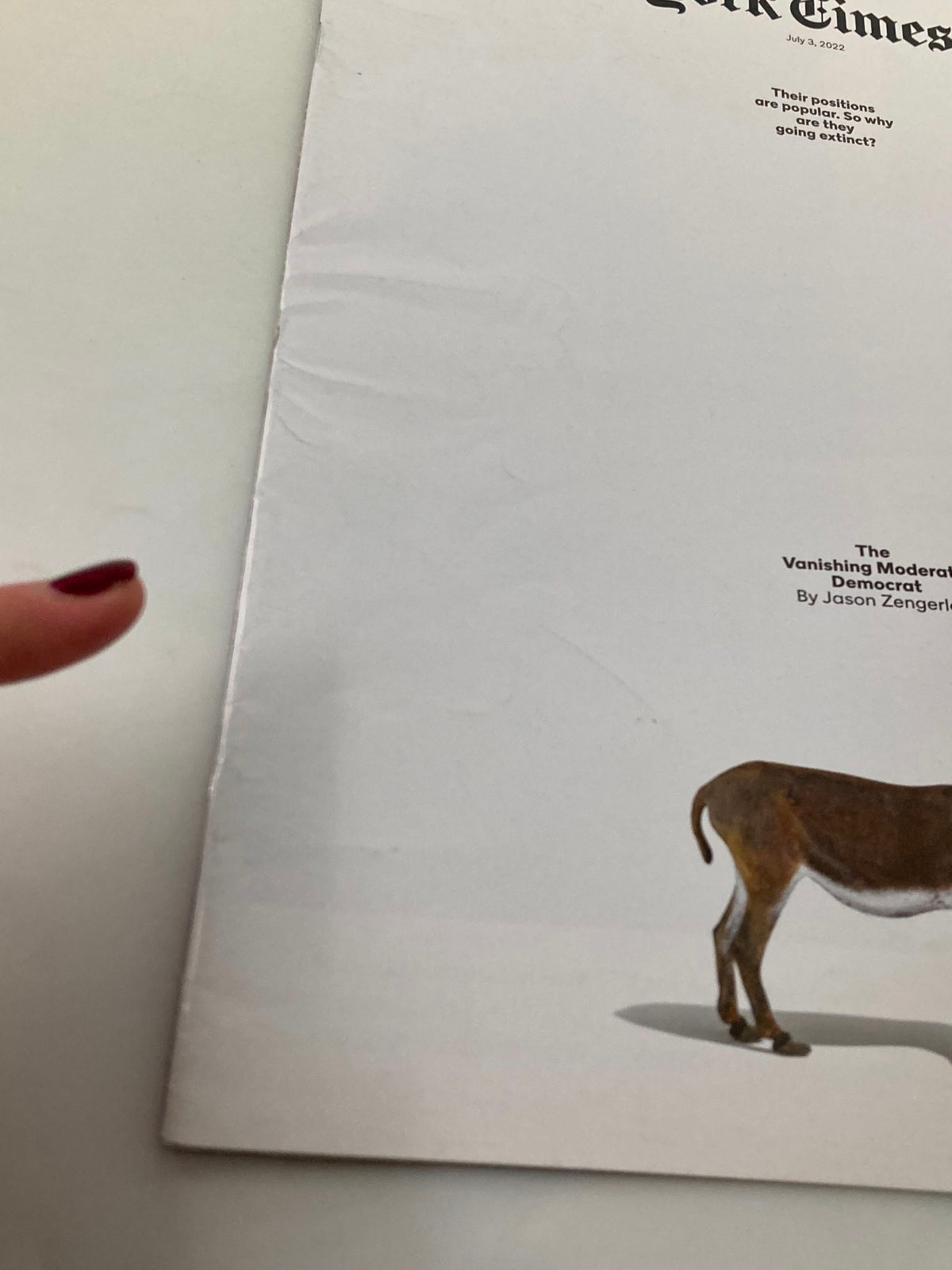 Side view of The New York Times Magazine July 3, 2022, displaying creases along the edge, maintaining focus on the article 'Vanishing Moderate Democrat'.