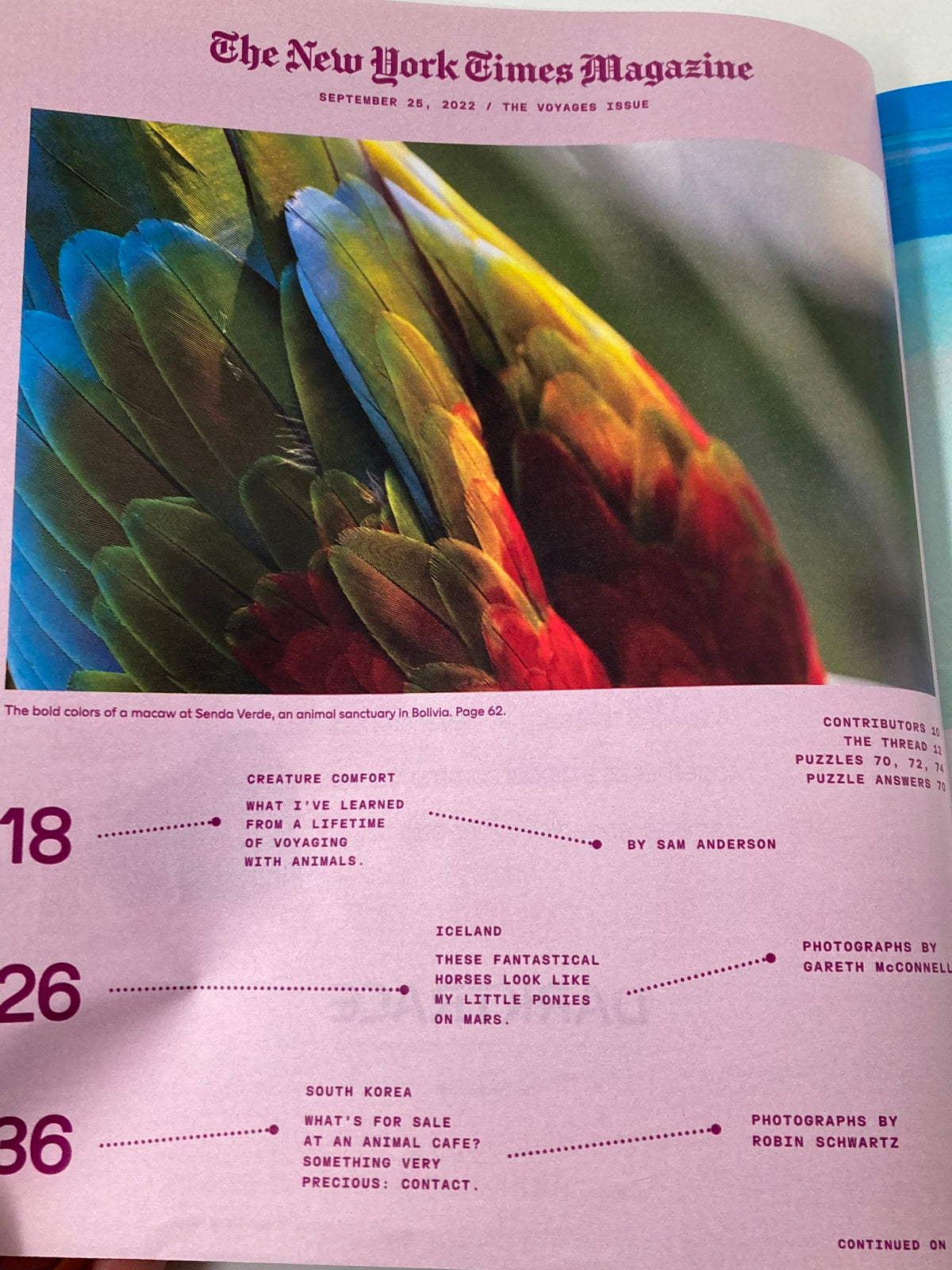Internal page of The New York Times Magazine September 25 2022 showcasing a colorful macaw's feathers, inclusively detailing articles about animal encounters and photography journeys.