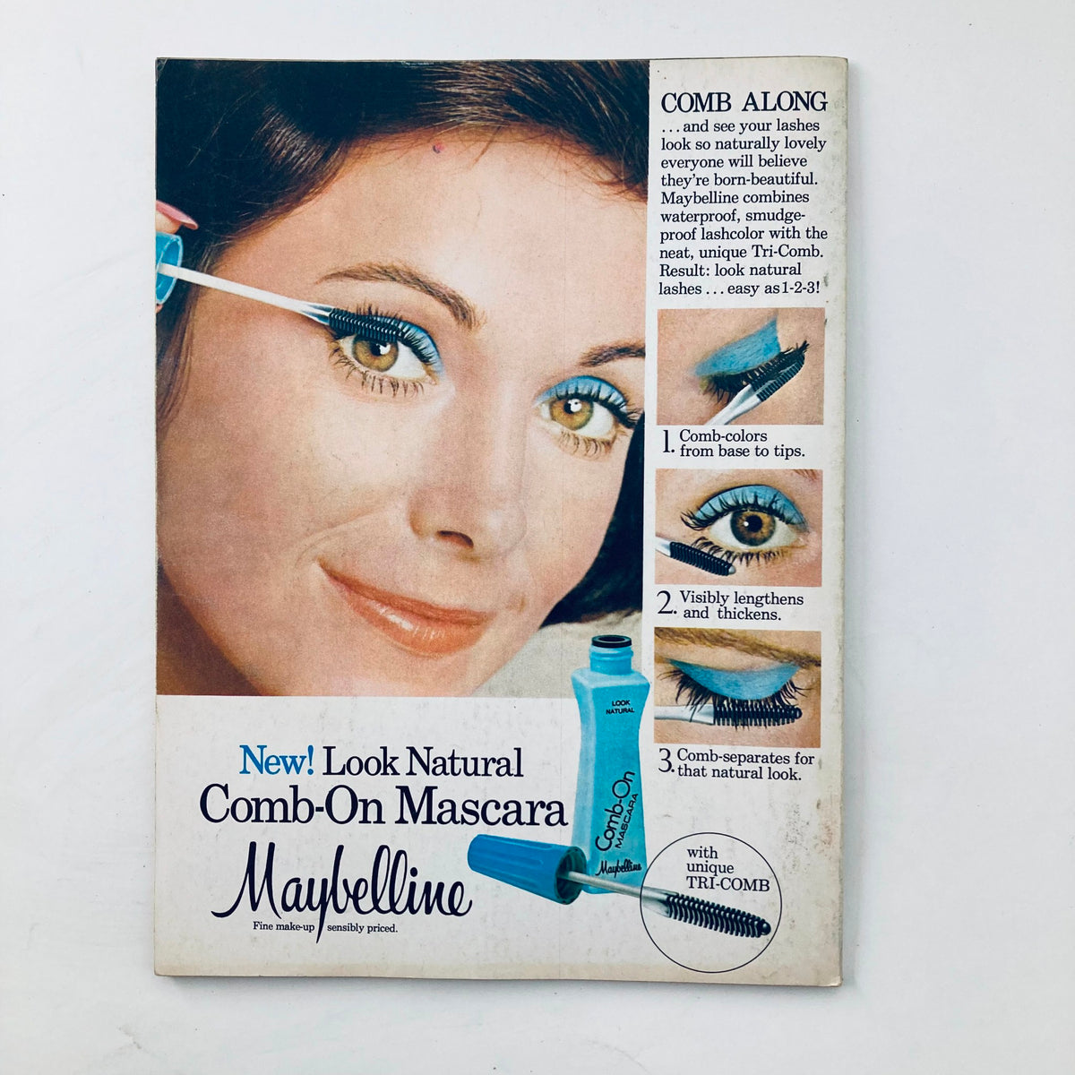 Vintage Maybelline advertisement from the VTG Tiger Beat Magazine November 1976, featuring a model promoting the 'Comb-On Mascara' highlighting beauty trends of the 1970s.