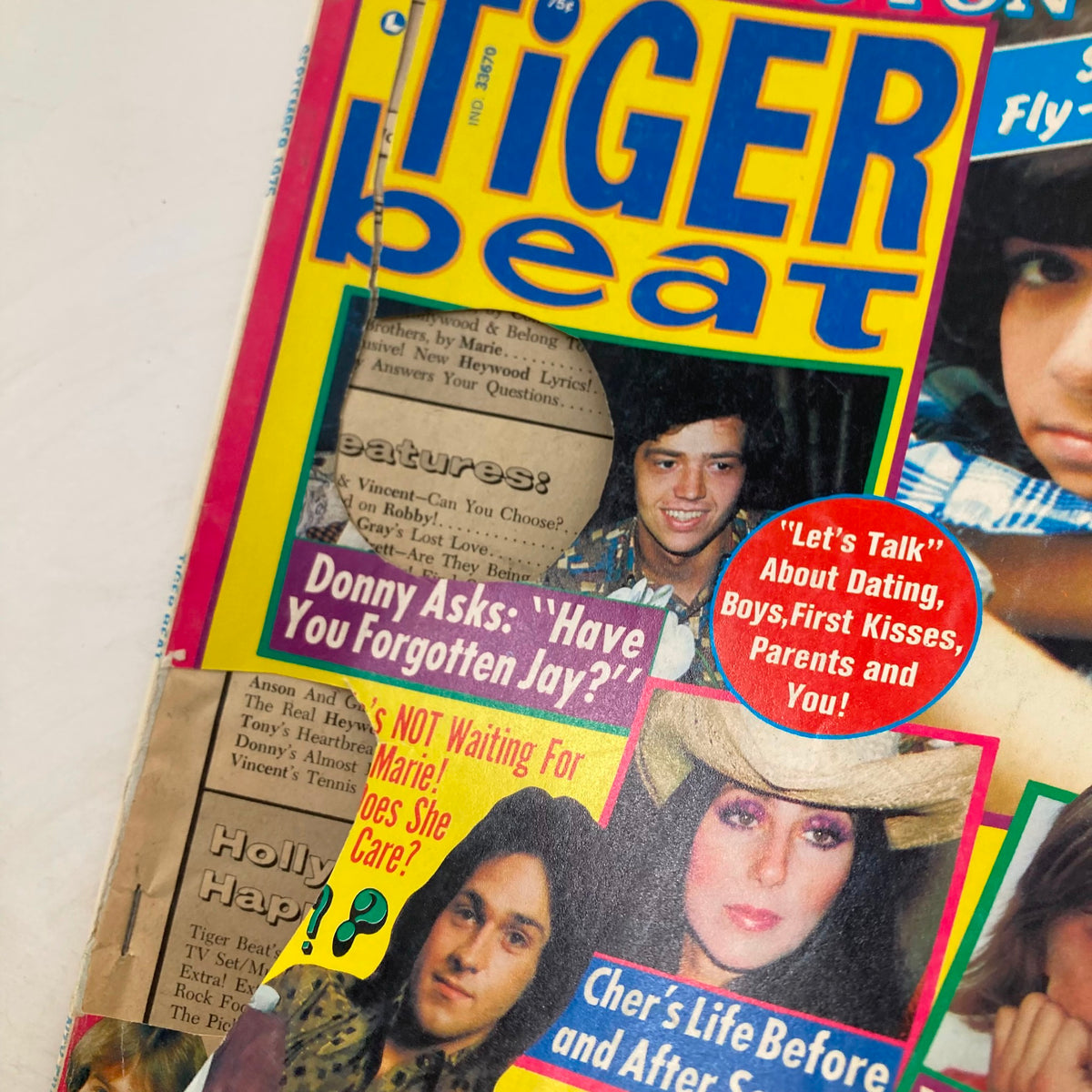 Close-up of the Tiger Beat Magazine September 1975 cover, highlighting articles related to dating and features on Donny & Marie Osmond and Cher.