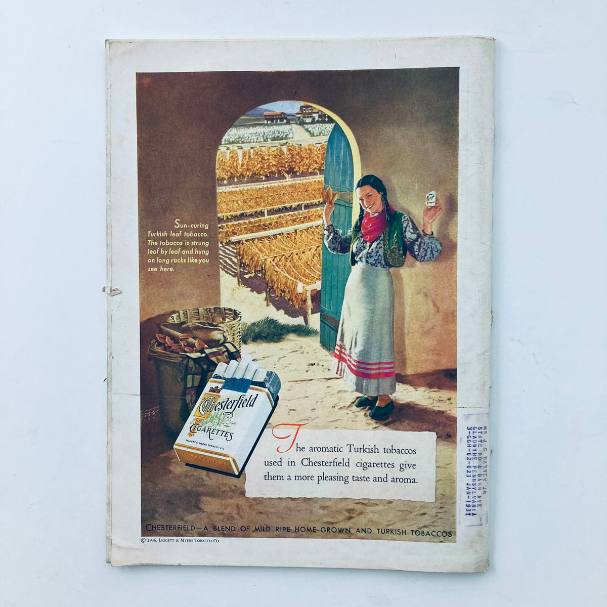 Vintage advertisement from VTG Time Magazine February 10, 1936 featuring Chesterfield cigarettes. The image showcases a woman holding cigarette packaging in a picturesque tobacco field setting.