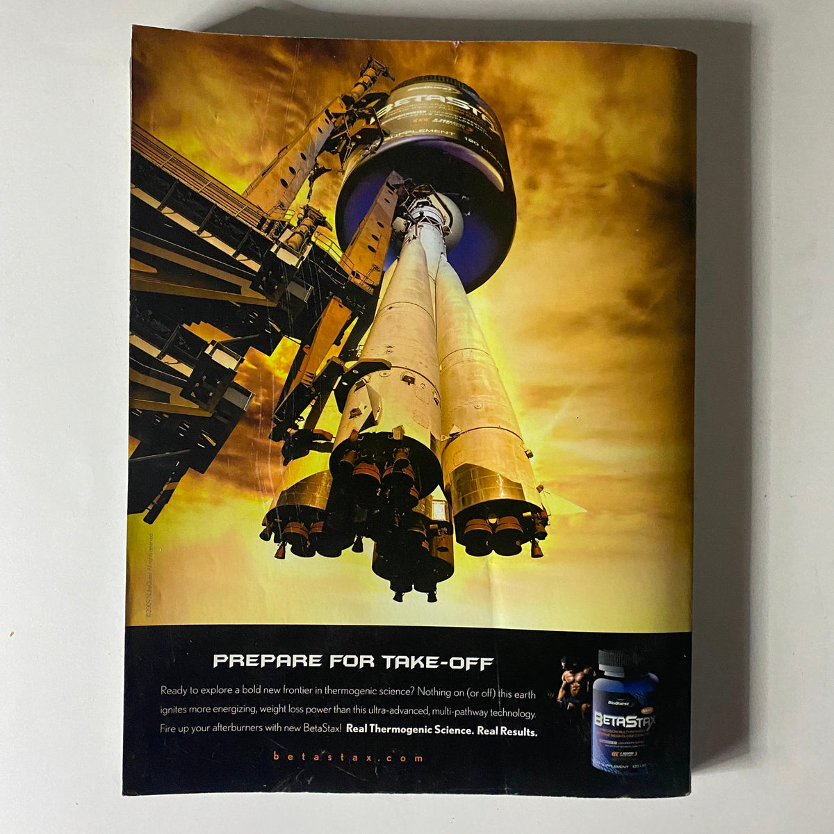 Back cover of Muscular Development Magazine June 2009, illustrating a powerful rocket launch with an advertisement for a thermogenic supplement.