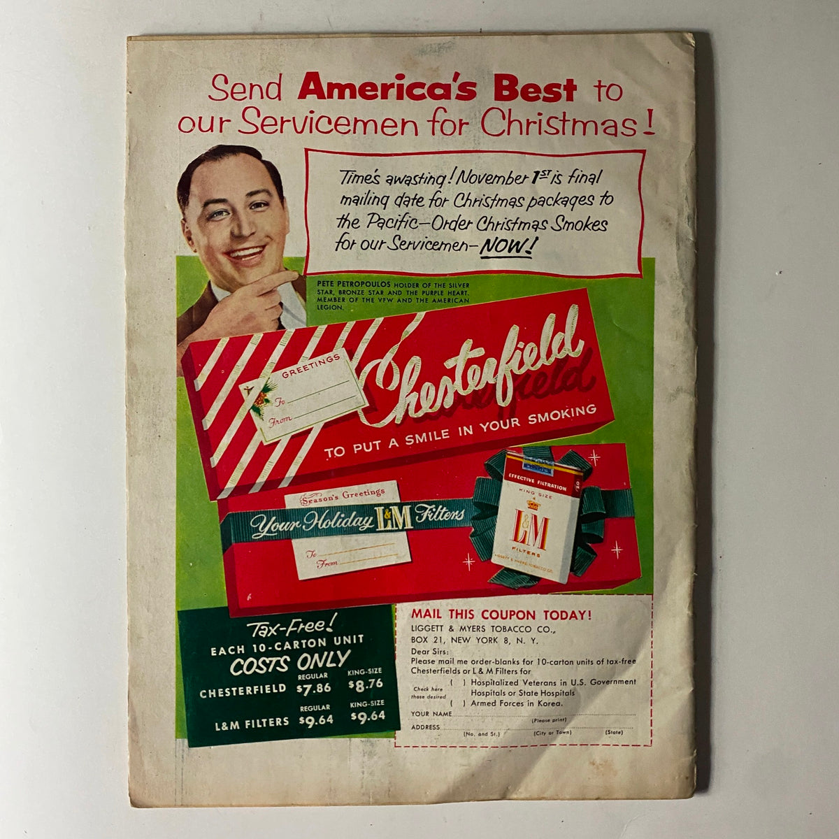 Back cover of The American Legion Magazine September 1955 showcasing an advertisement for Chesterfield cigarettes with festive holiday messaging directed at American servicemen.