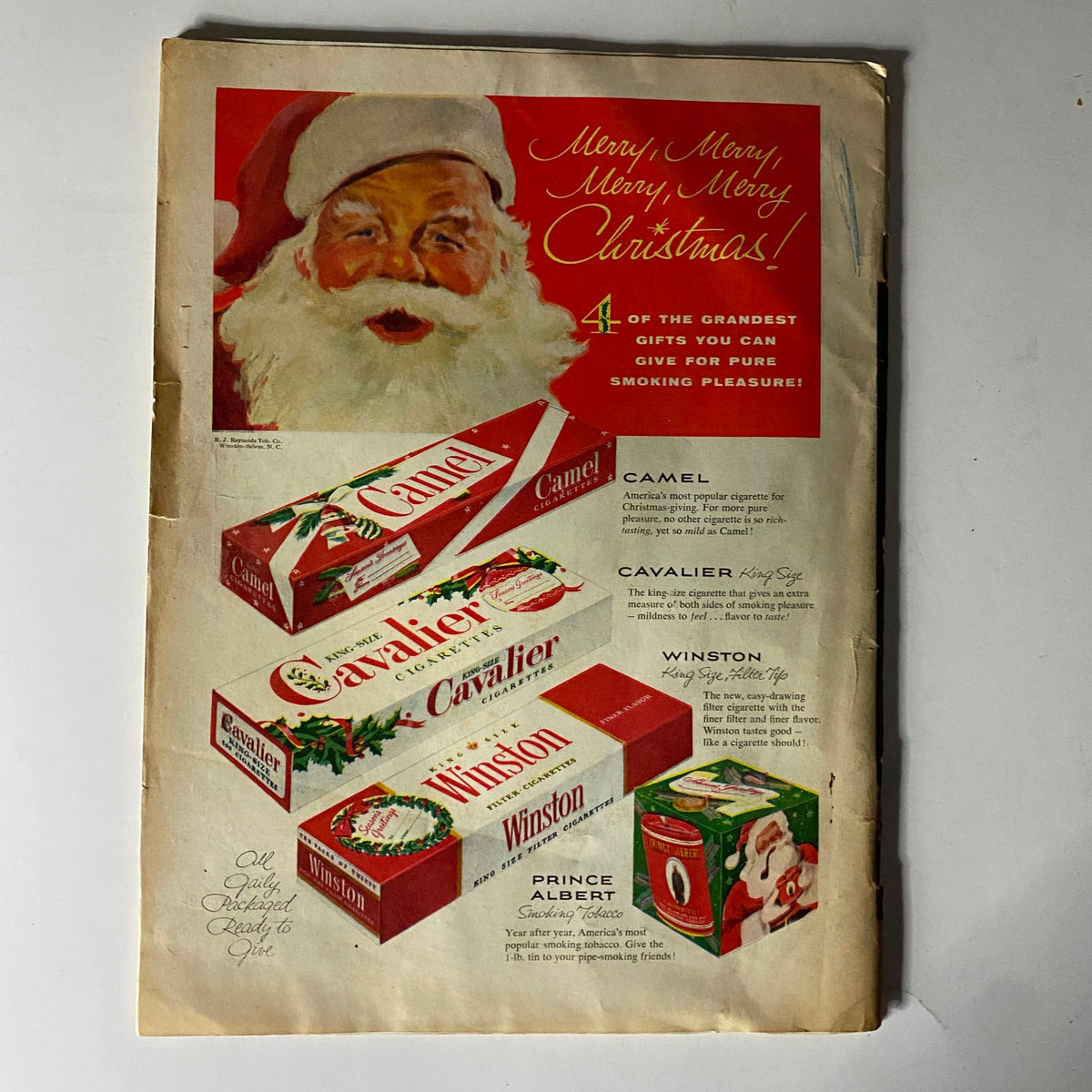Advertisement page from The American Legion Magazine December 1954 showcasing various cigarette brands, featuring Santa Claus and Christmas-themed promotions for Camel, Cavalier, and Winston.