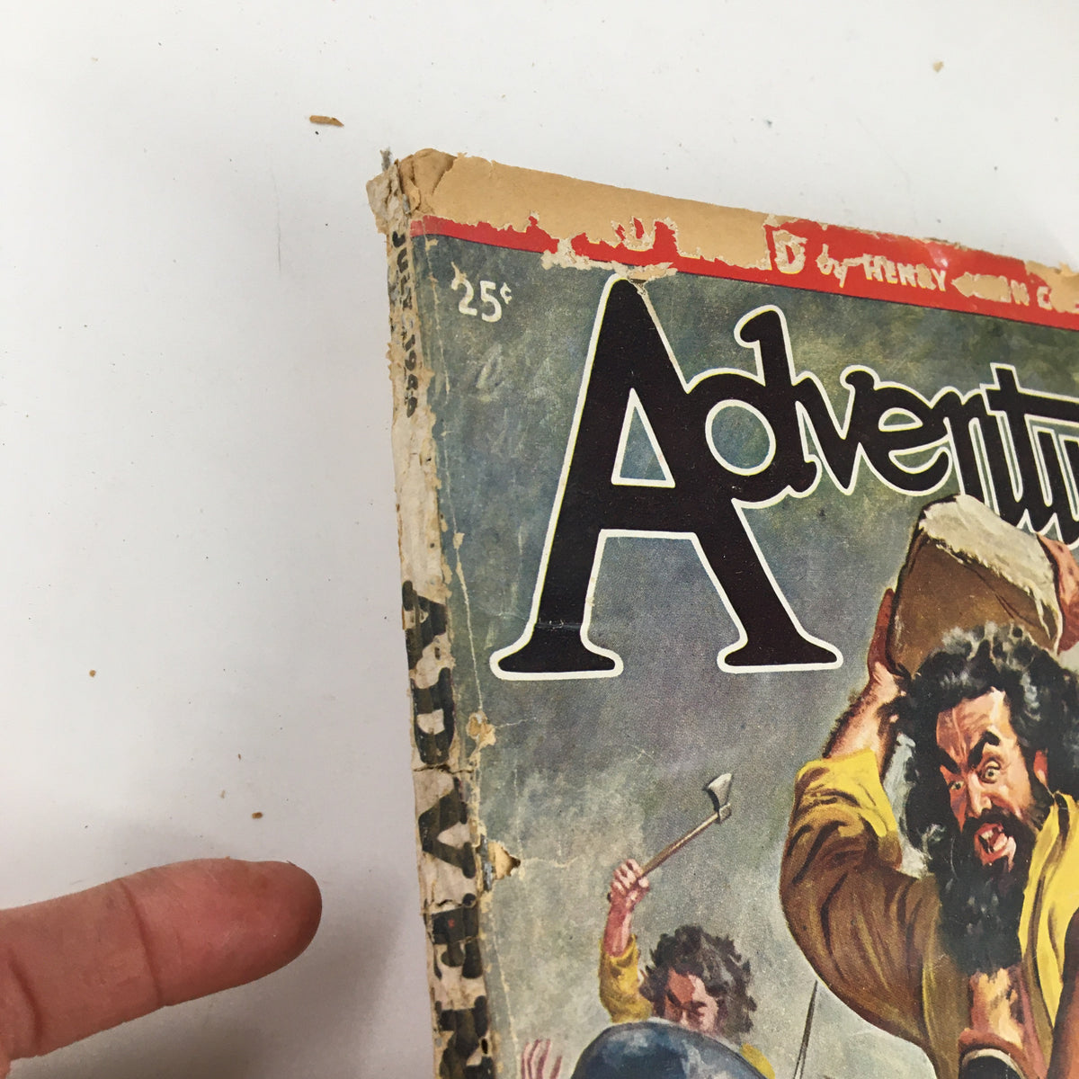Close-up of the top corner of VTG Adventure Magazine July 1946 cover, showing the magazine's title and a man lifting a stone.